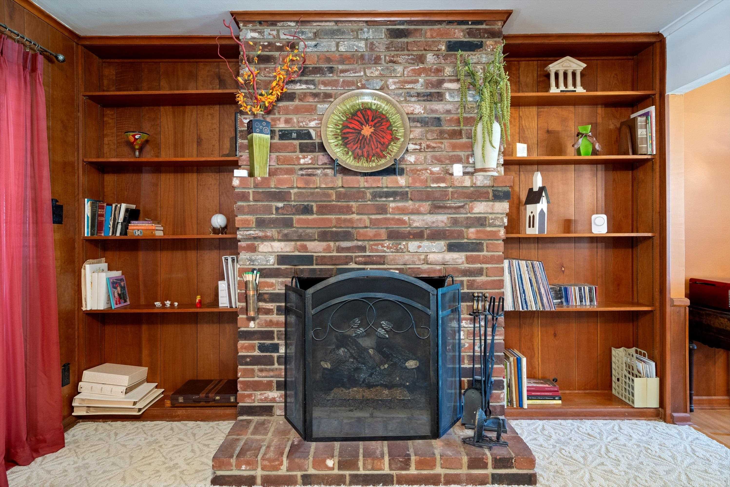 Living room with crown molding and a fireplace