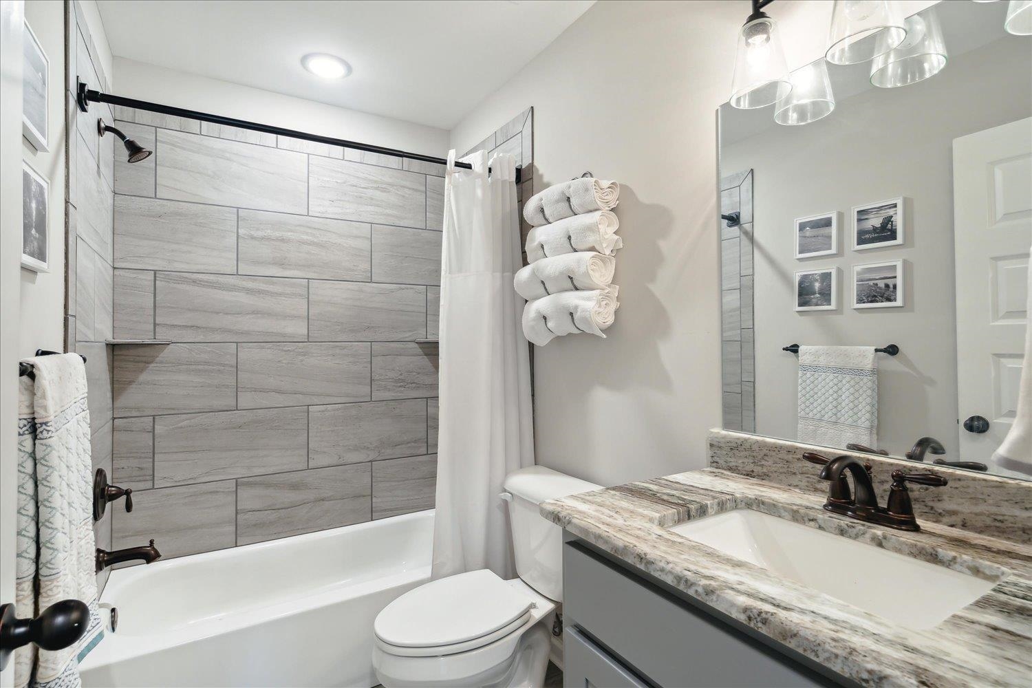 Full bathroom featuring vanity, toilet, and shower / tub combo with curtain