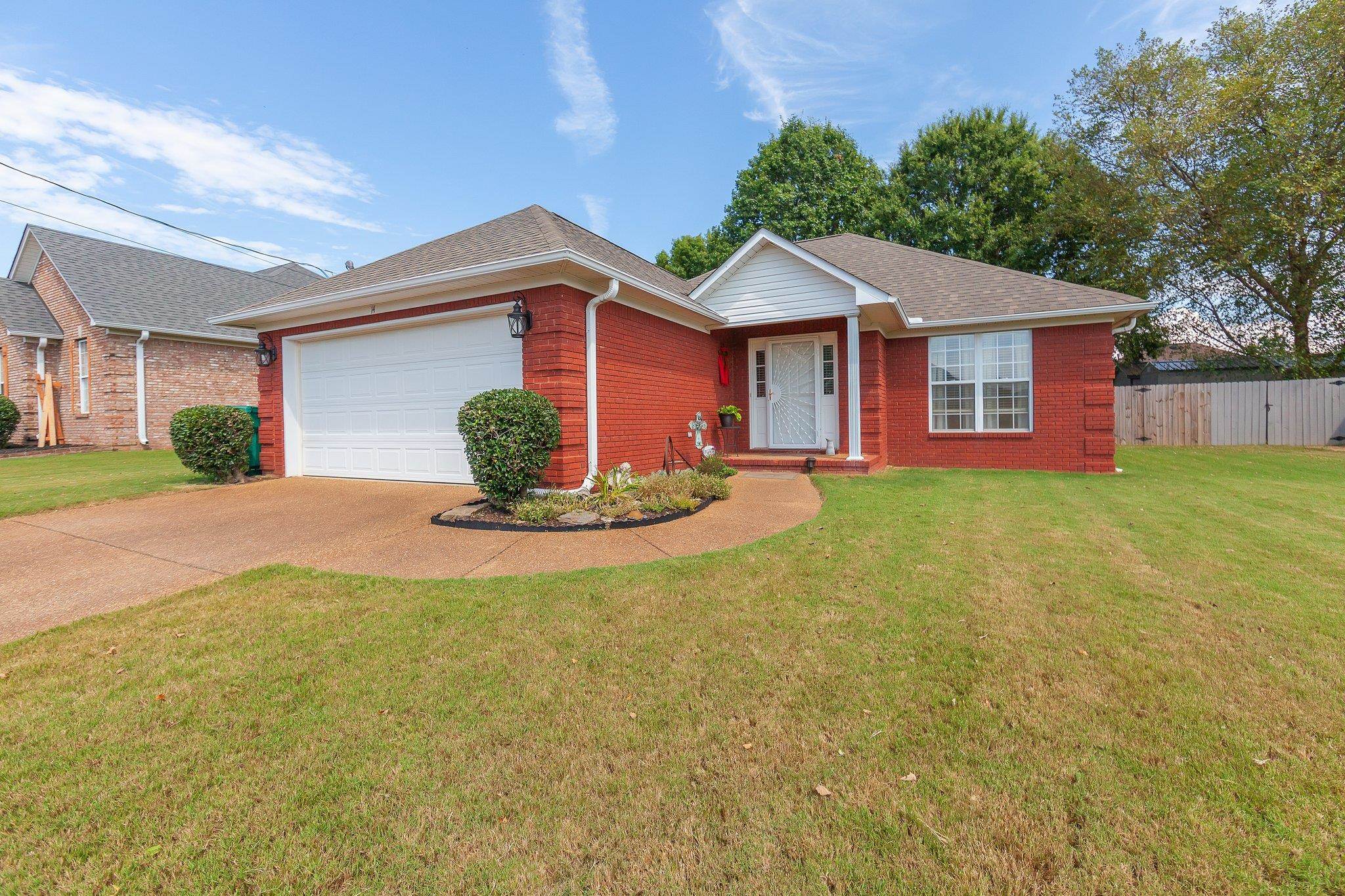 Ranch-style home with a garage and a front yard