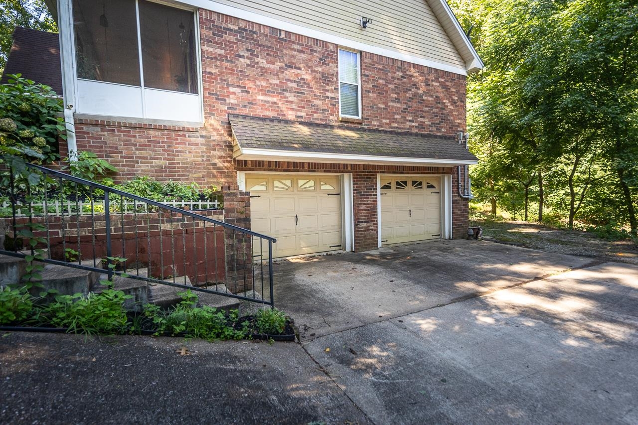 View of side of property with a garage