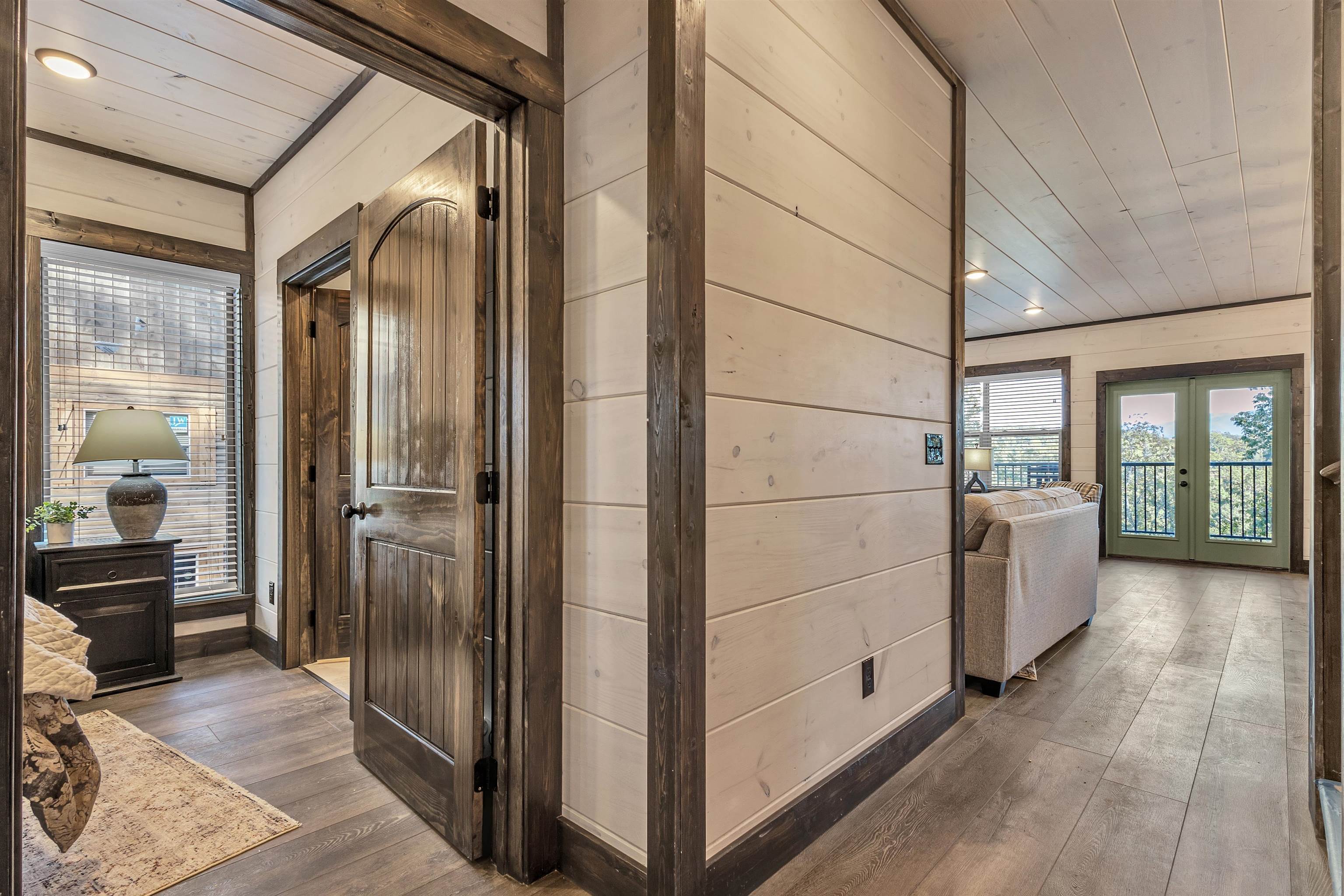 Hall featuring wooden ceiling, french doors, dark hardwood / wood-style flooring, and wood walls