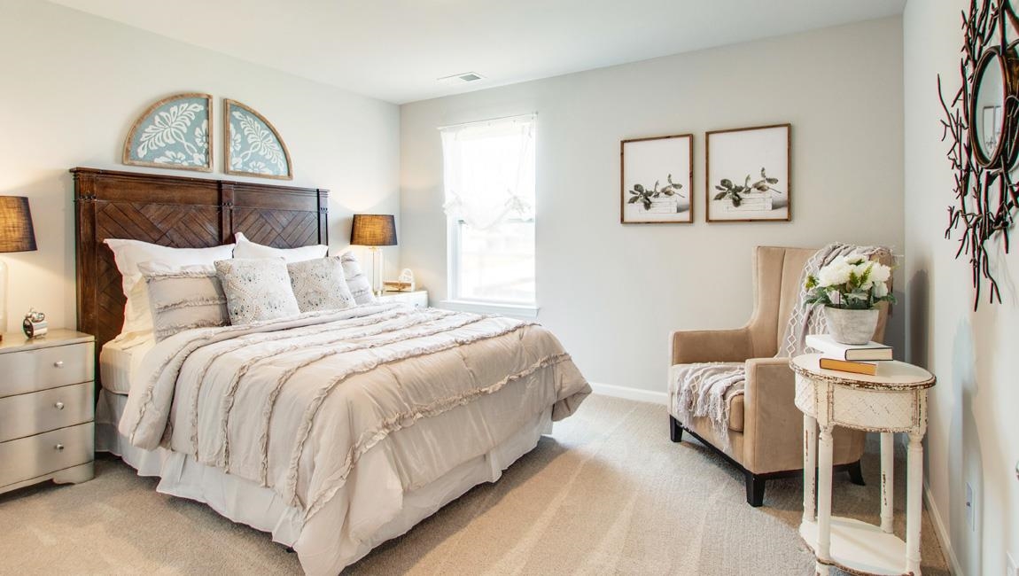 Bedroom featuring light colored carpet