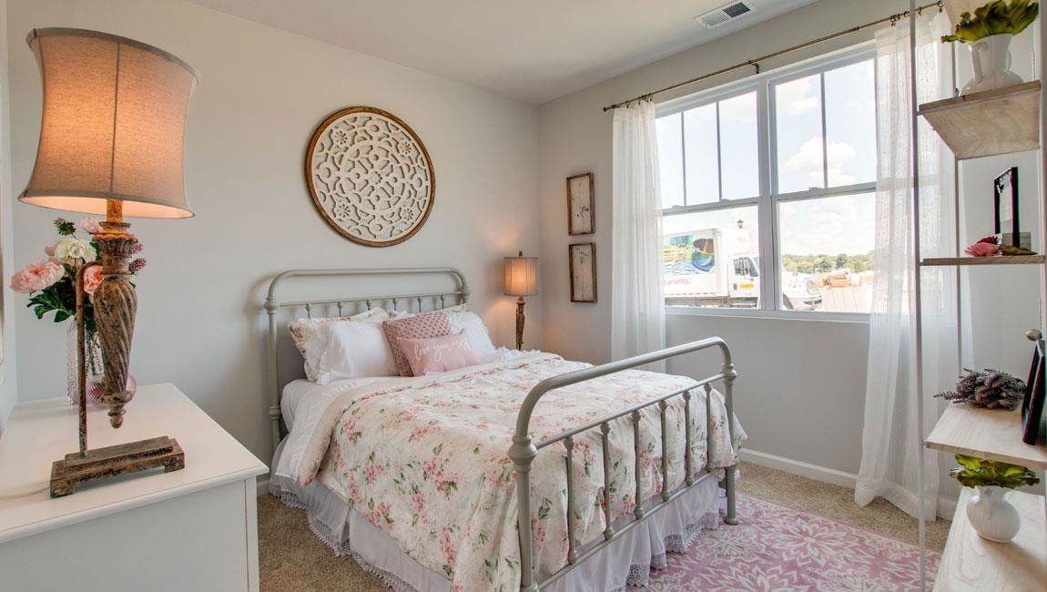 Carpeted bedroom with multiple windows