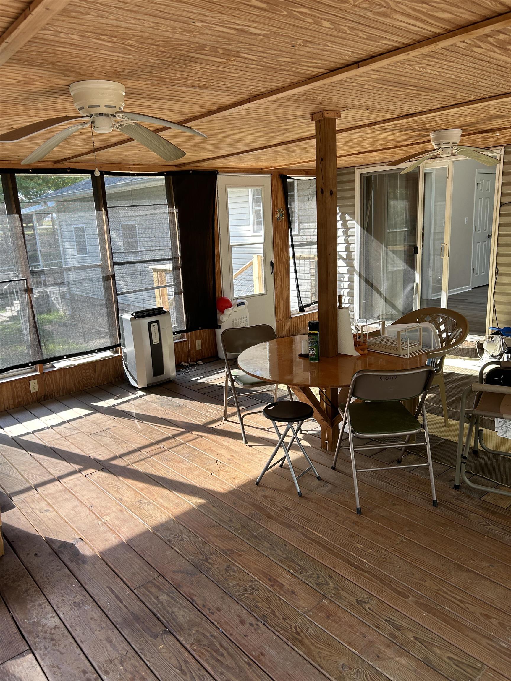 Sunroom featuring wooden ceiling and ceiling fan