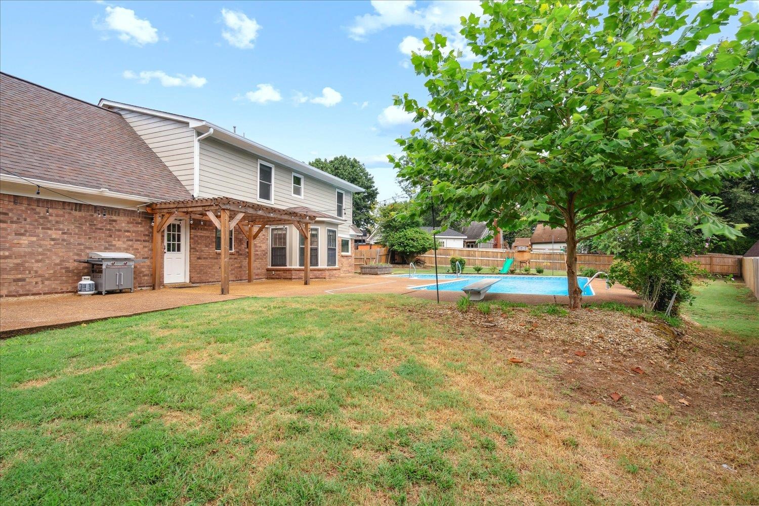 View of yard with a fenced in pool, a pergola, and a patio area