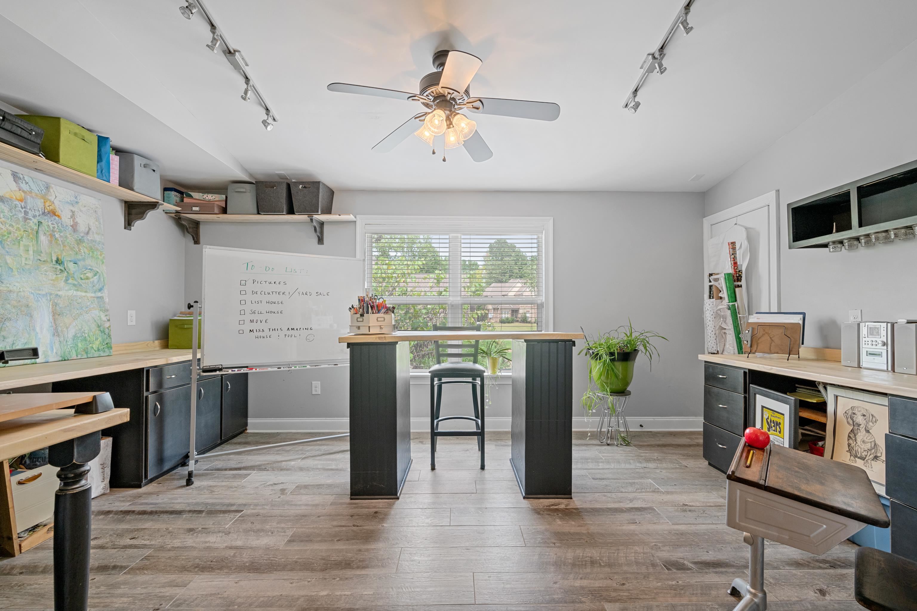 Interior space with track lighting, light hardwood / wood-style flooring, and ceiling fan