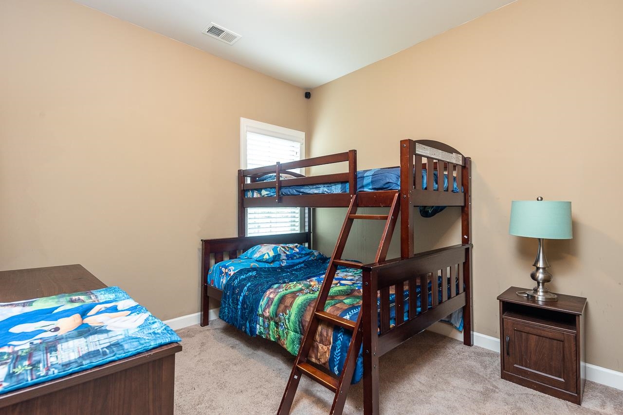 Bedroom featuring light colored carpet