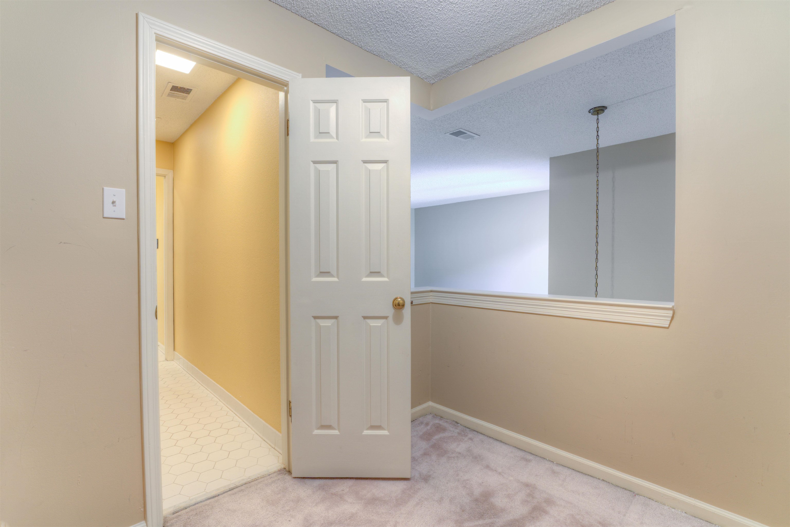 Hall featuring carpet and a textured ceiling