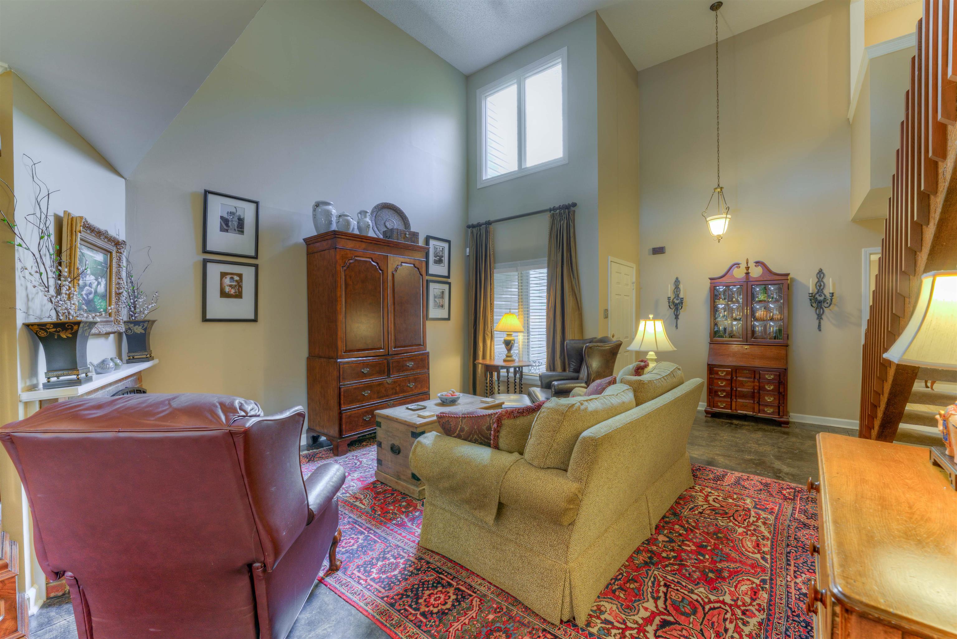 Living room featuring high vaulted ceiling