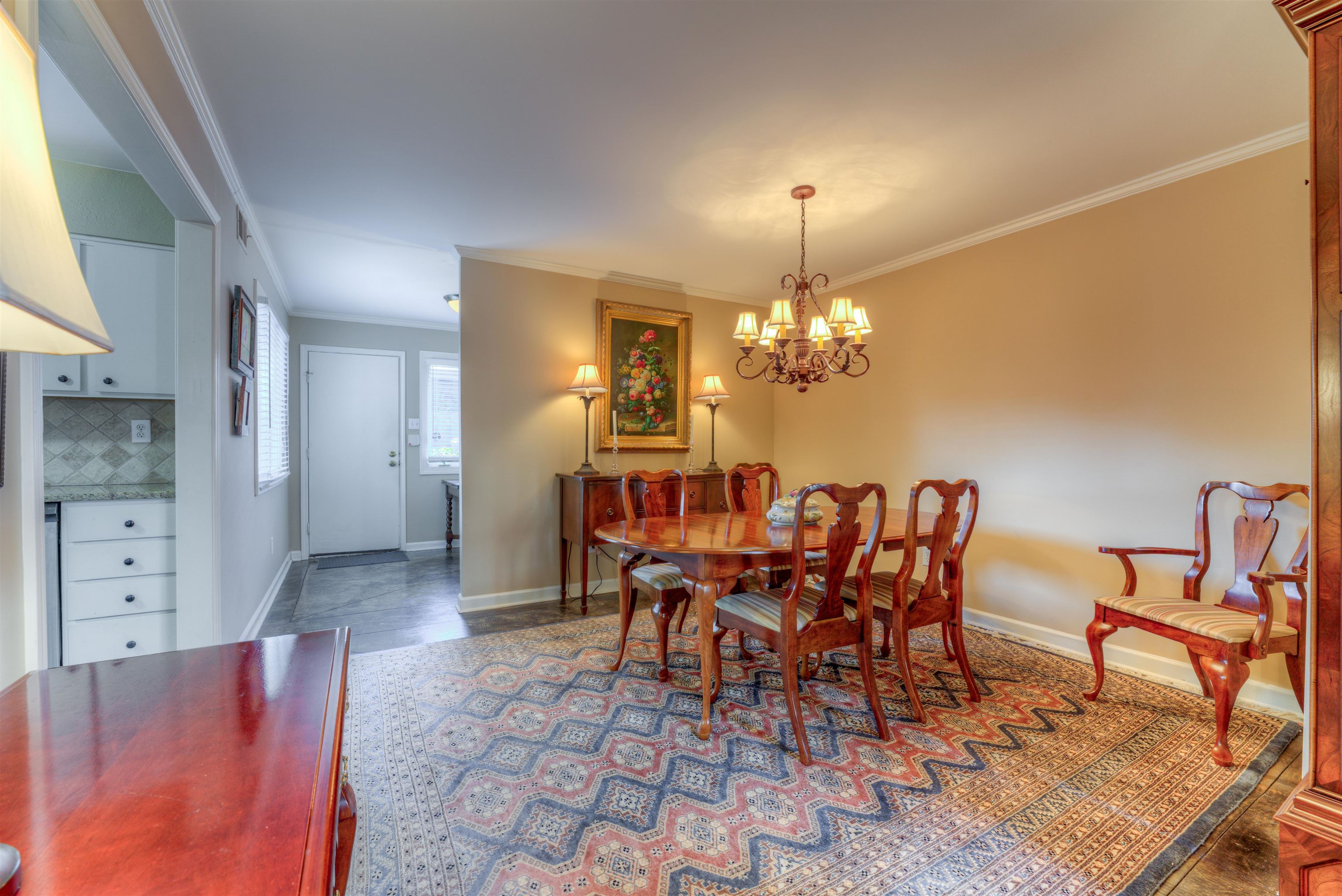 Dining area featuring ornamental molding and a chandelier