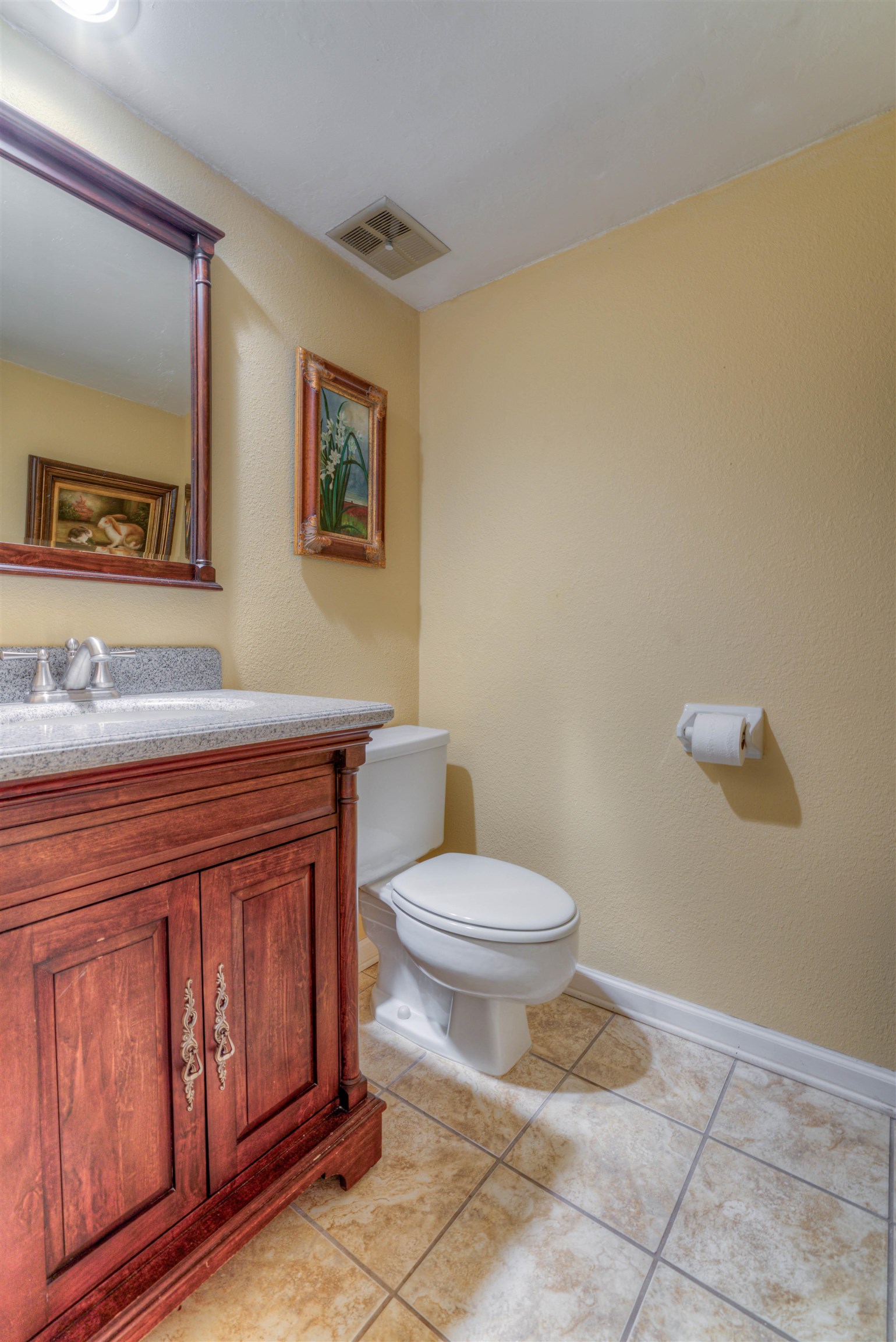 Powder room Bathroom featuring vanity, toilet, and tile patterned flooring