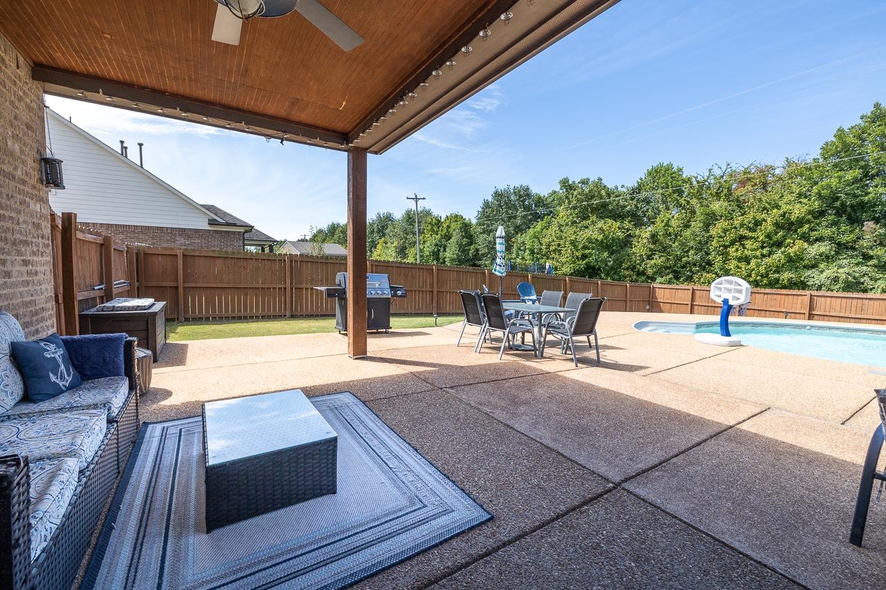 View of covered patio with plenty of entertaining area.  Ceiling Fan, Extended concrete