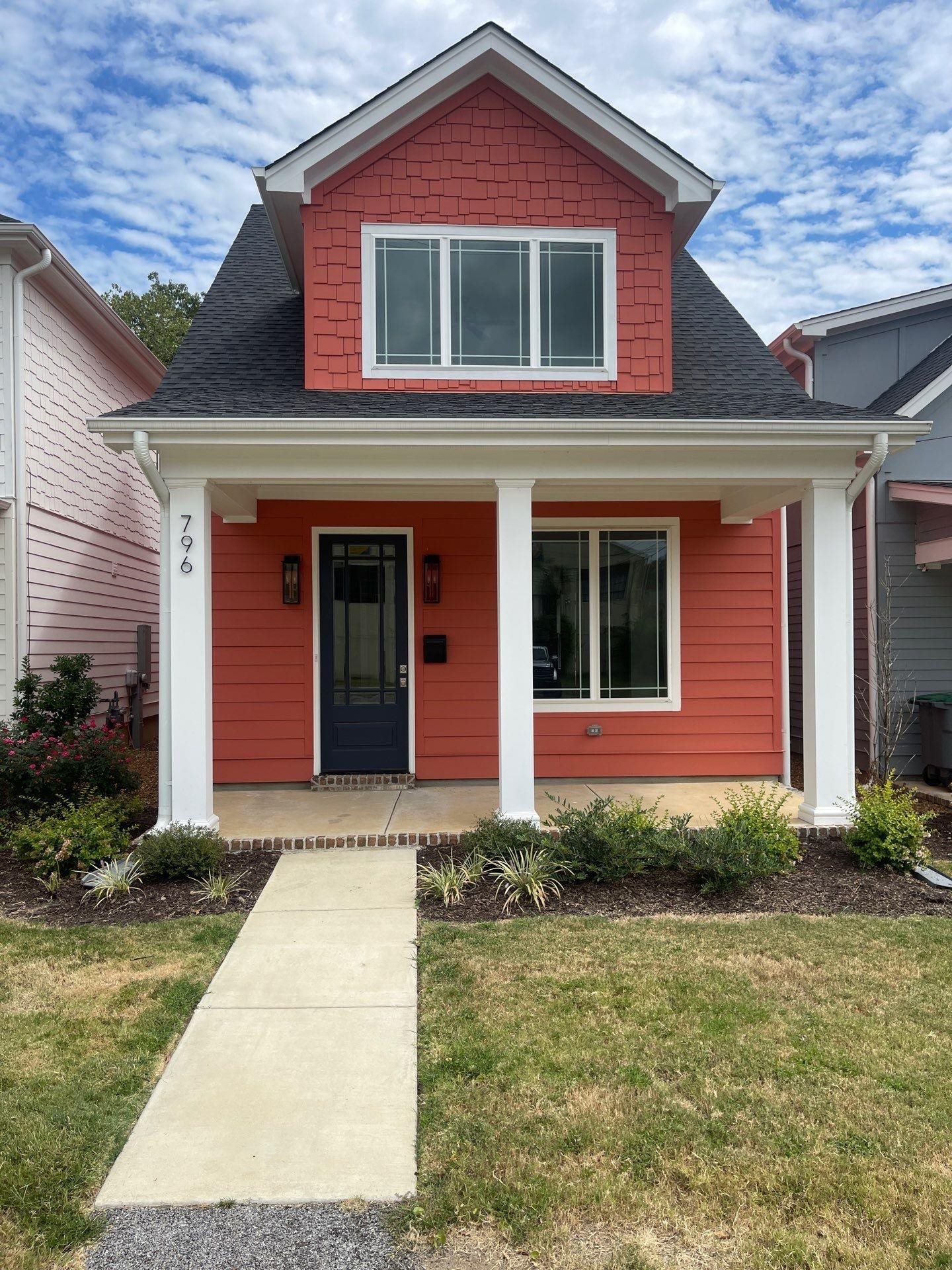View of front of home with a front lawn and covered porch