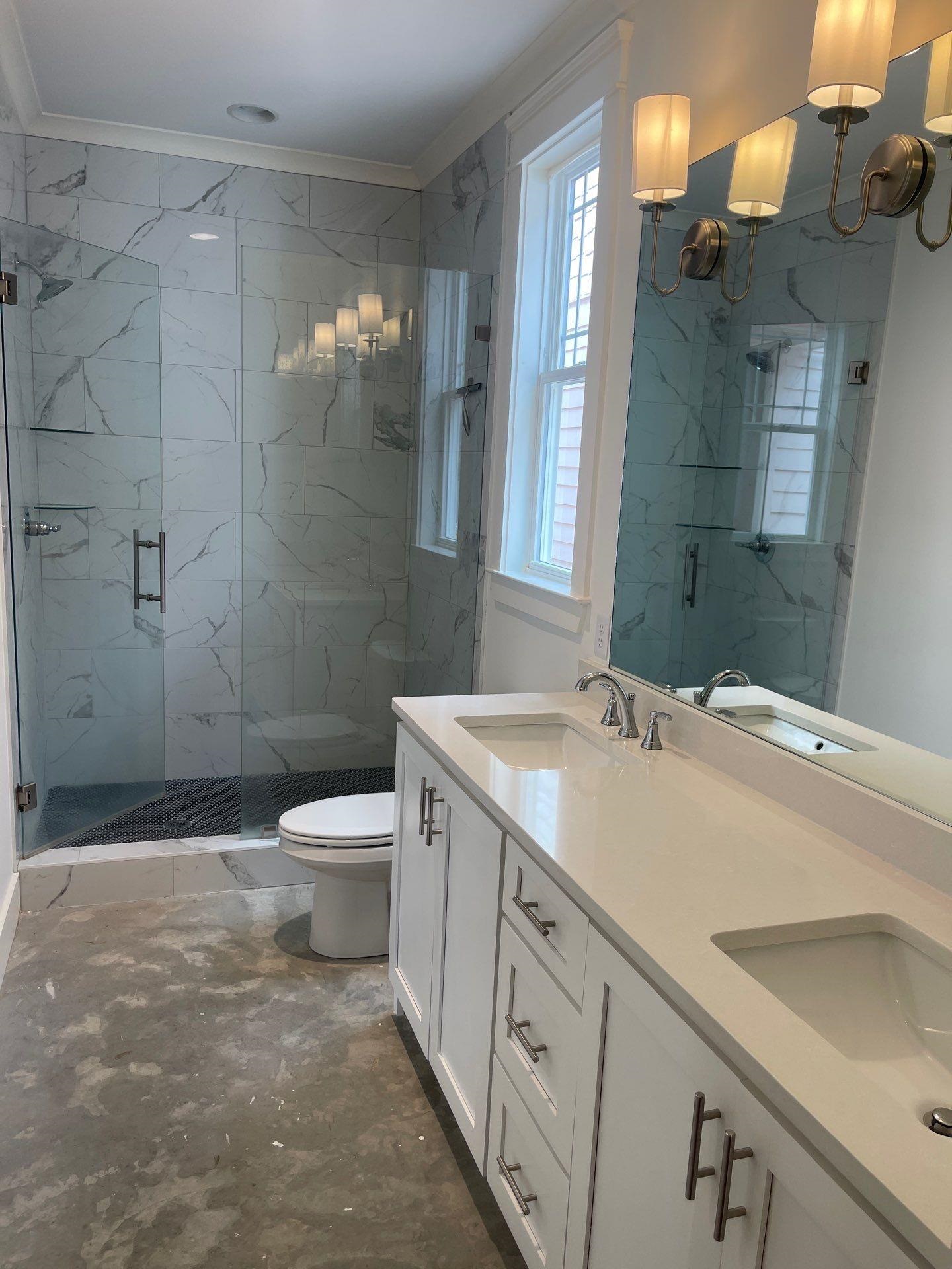 Bathroom featuring a shower with shower door, toilet, ornamental molding, and vanity