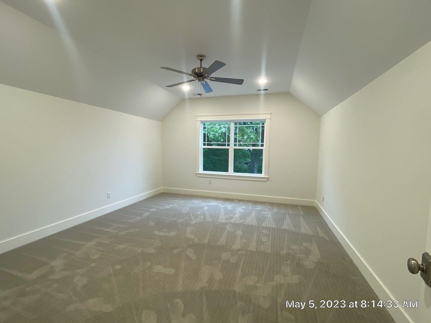 Bonus room featuring ceiling fan, carpet, and vaulted ceiling