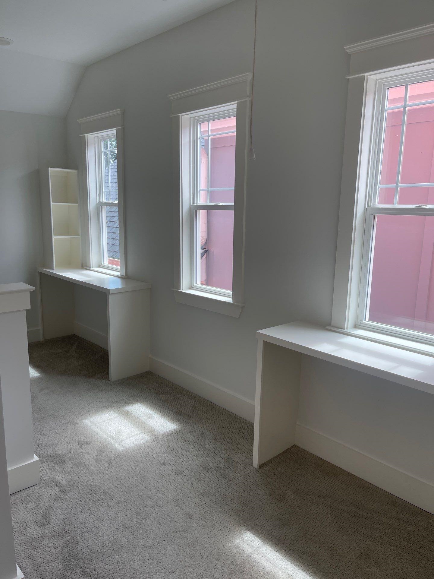 Empty room featuring a healthy amount of sunlight, vaulted ceiling, and light carpet