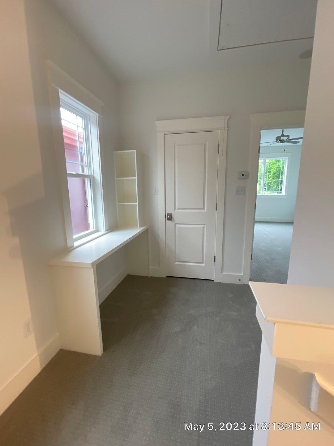 Interior space featuring ceiling fan and carpet flooring