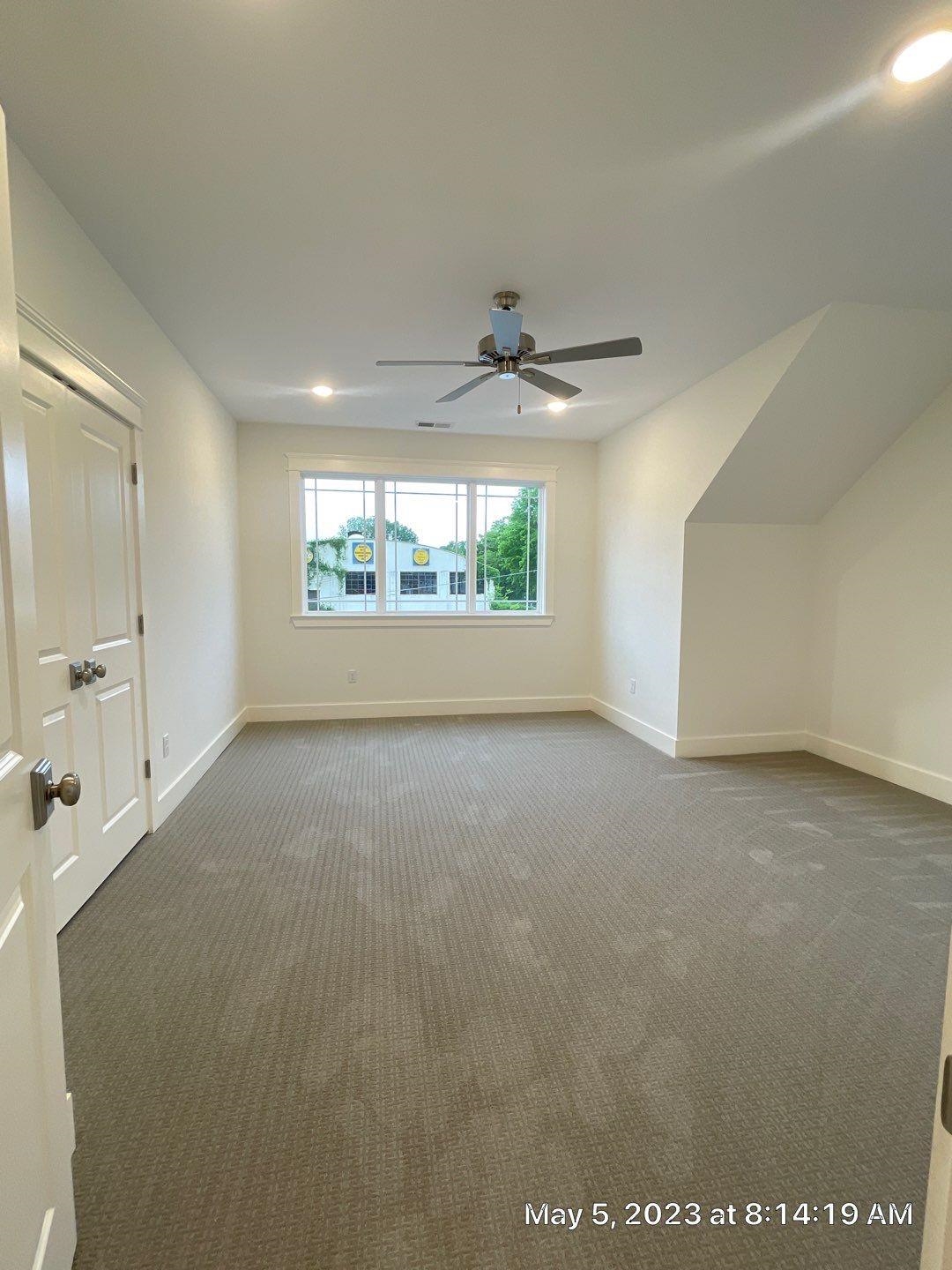 Bonus room with carpet and ceiling fan