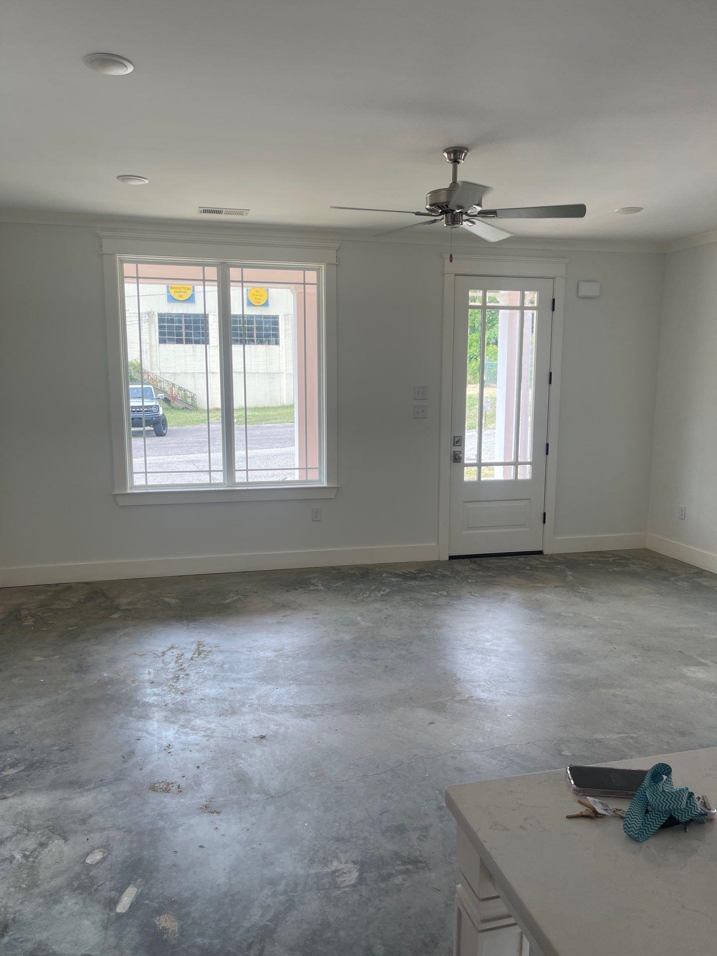 Empty room featuring ornamental molding, concrete floors, and ceiling fan