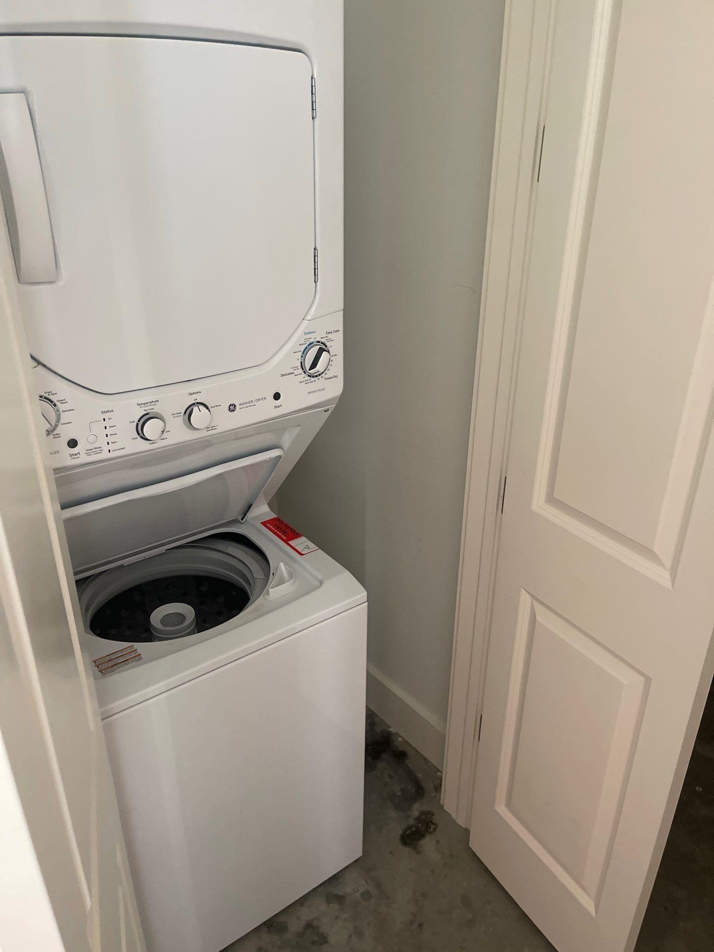 Laundry room featuring stacked washer / drying machine