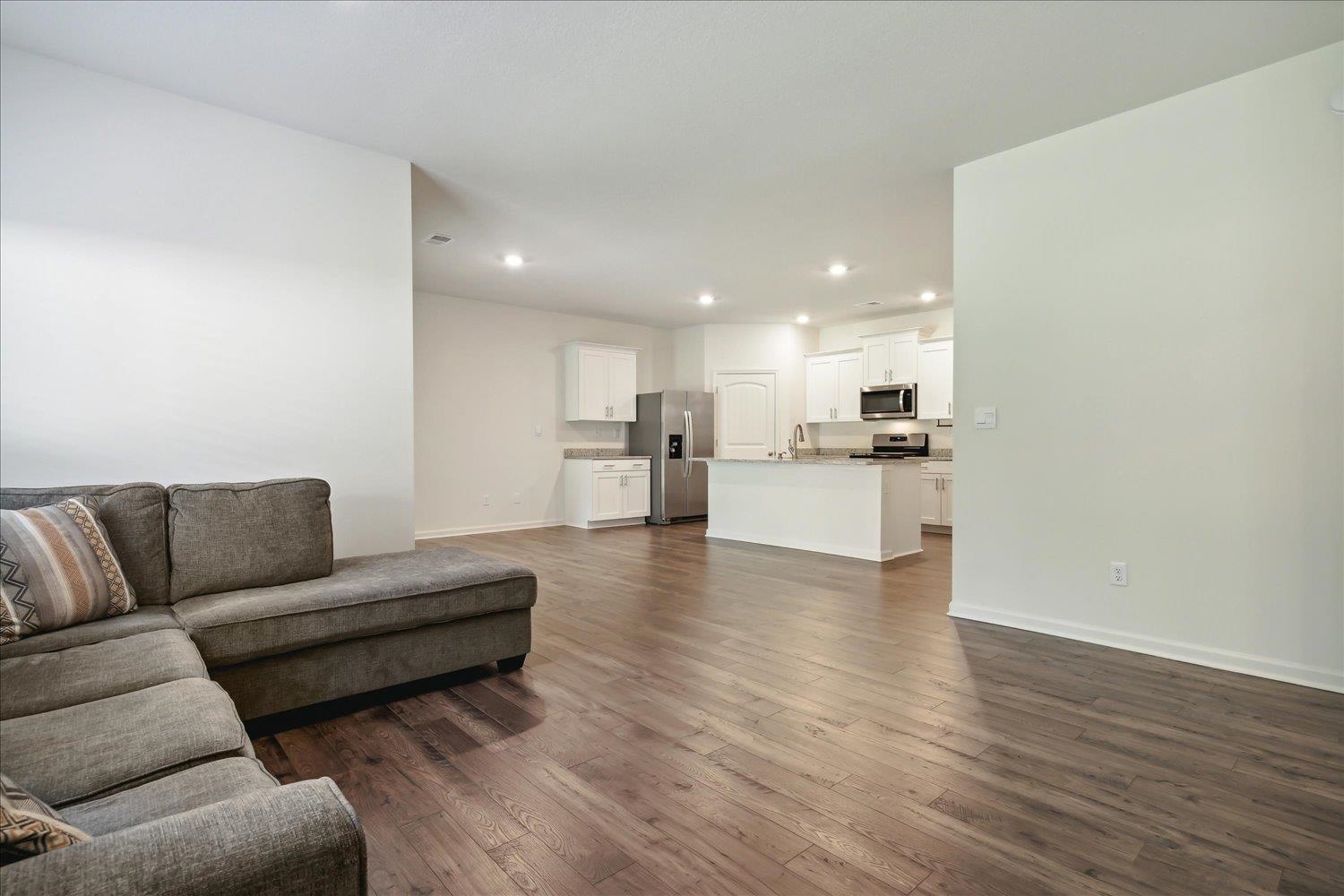 Living room with sink and dark hardwood / wood-style floors