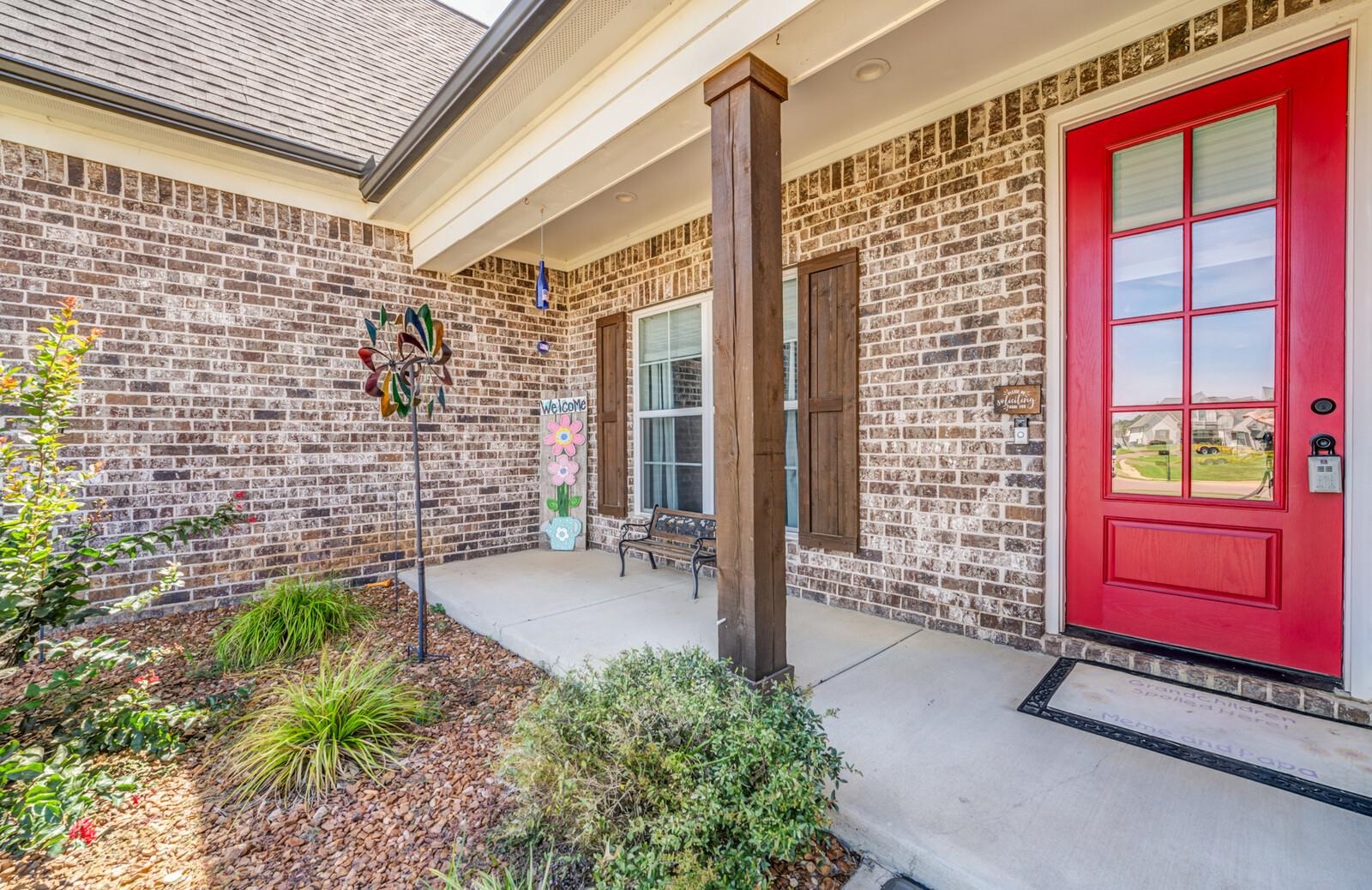 Doorway to property featuring covered porch