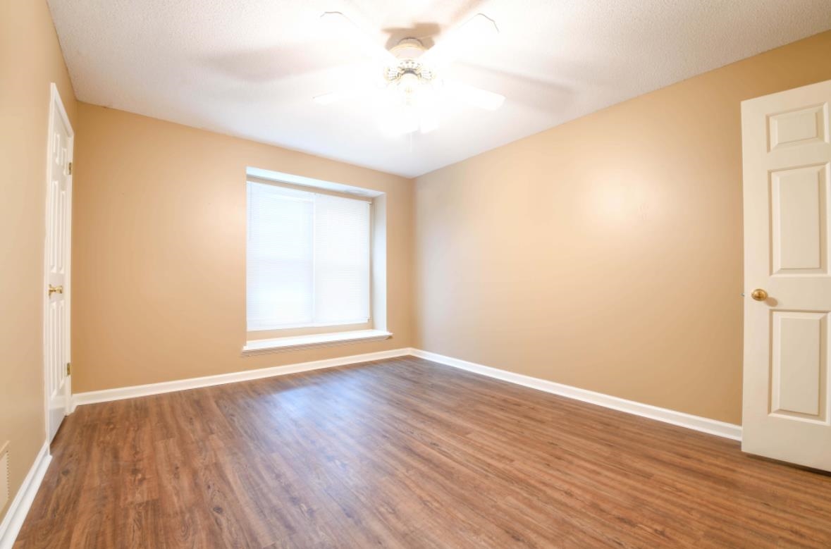 Spare room featuring ceiling fan and wood-type flooring