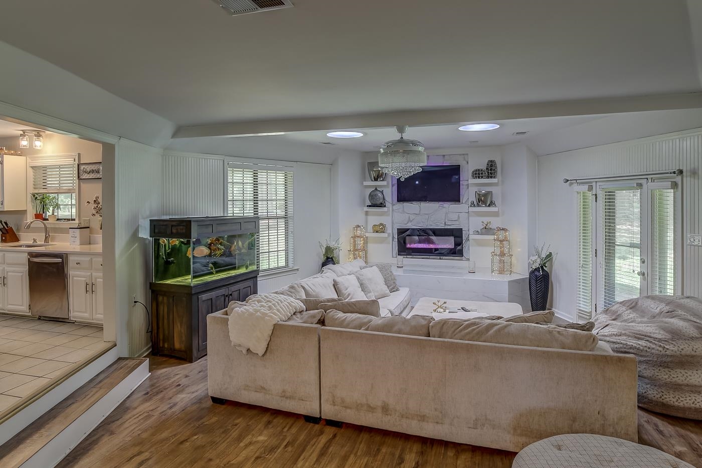 Living room featuring a fireplace, hardwood / wood-style flooring, and sink