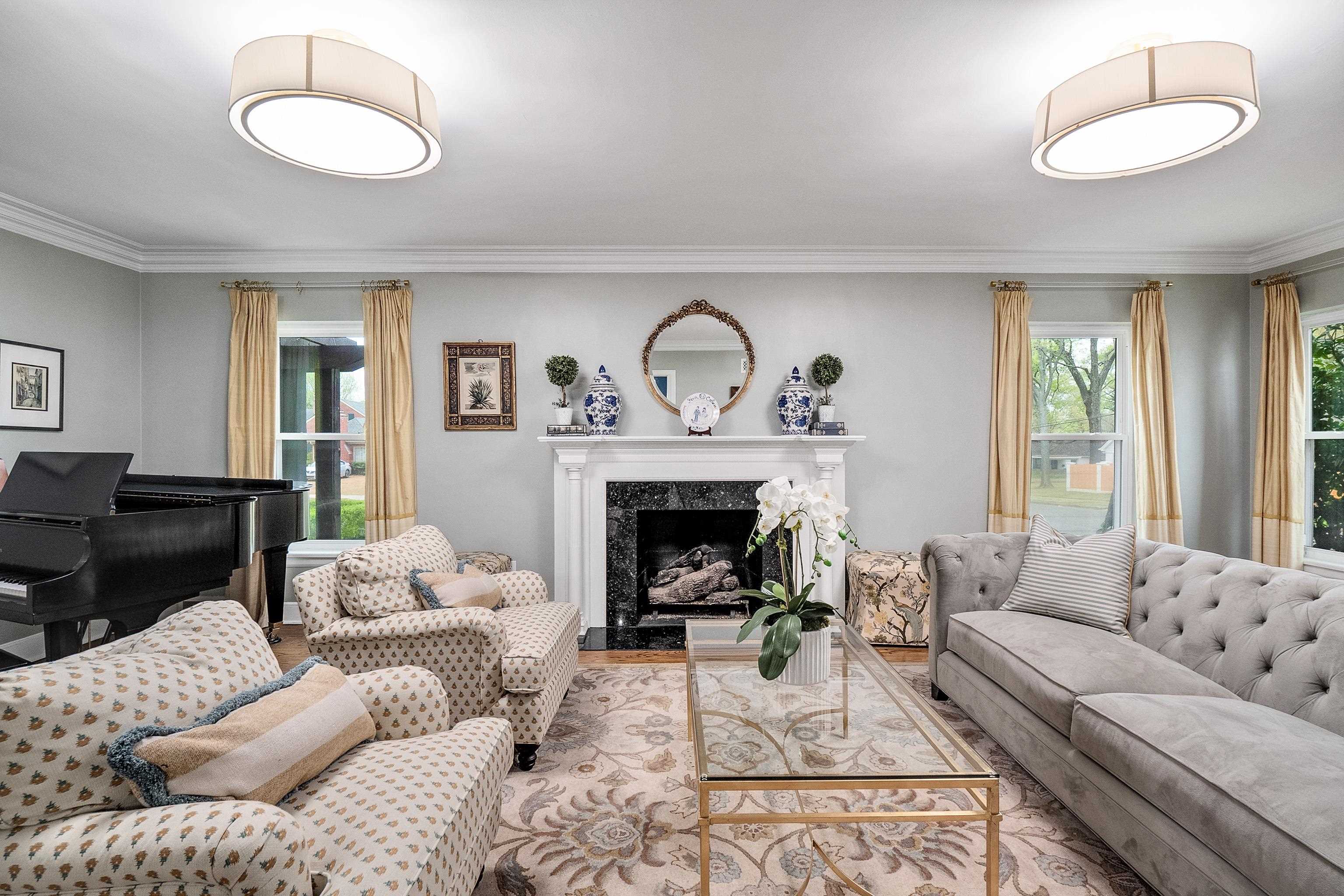 Living room featuring hardwood floors, crown molding, and a high end gas fireplace