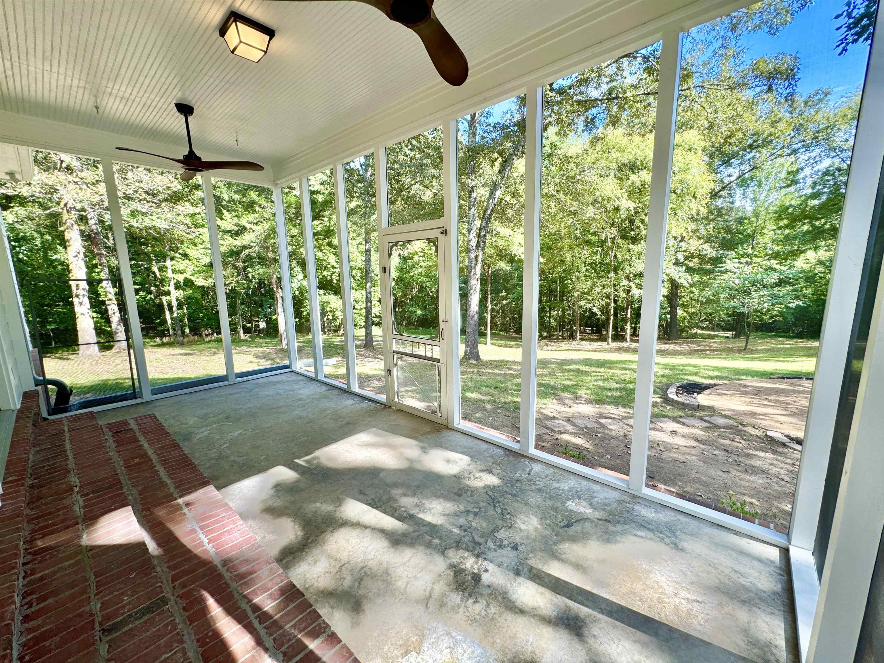 Unfurnished sunroom featuring ceiling fan and a healthy amount of sunlight