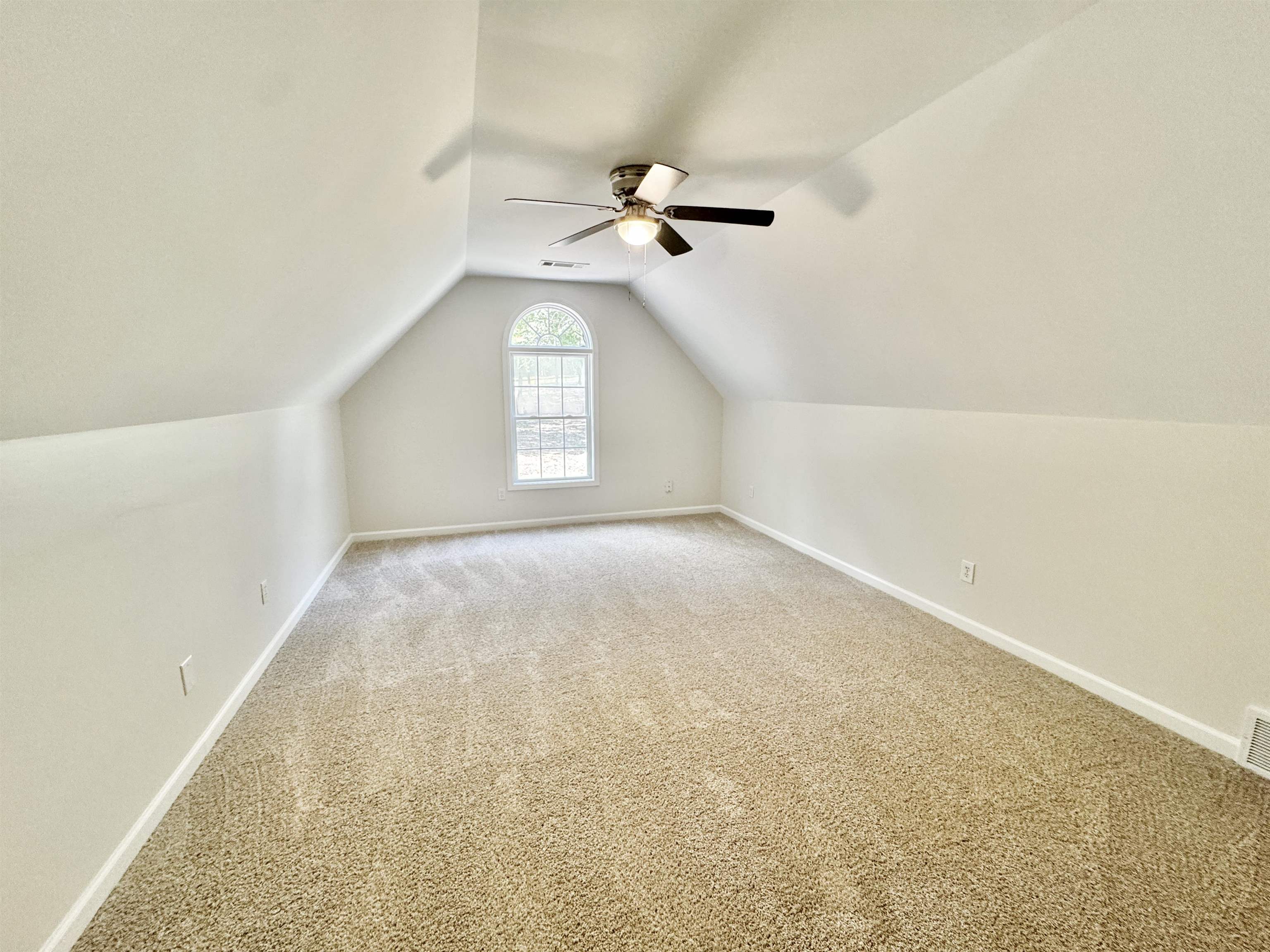 Bonus room featuring lofted ceiling, carpet flooring, and ceiling fan