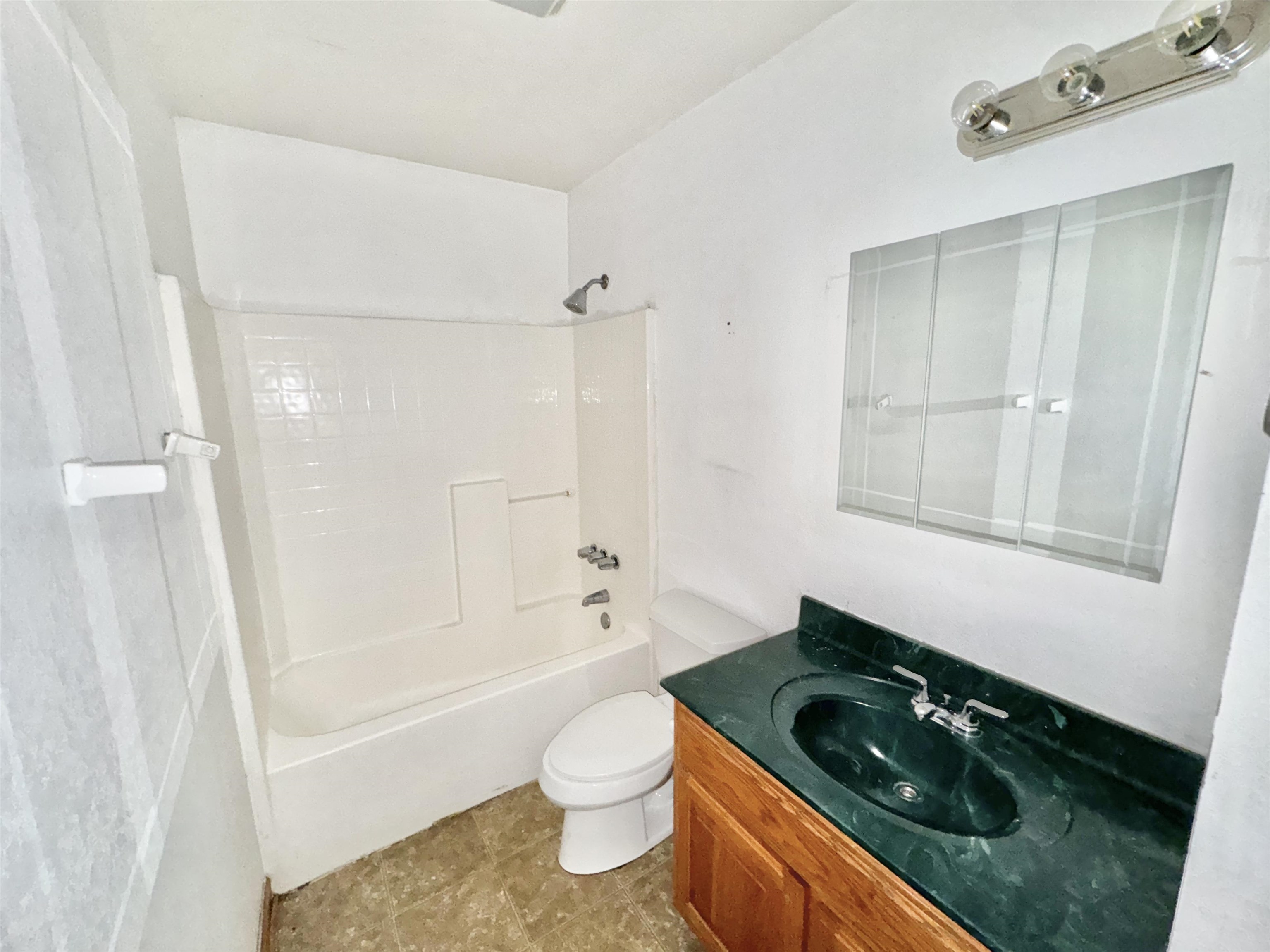 Full bathroom featuring shower / bathtub combination, toilet, and vanity