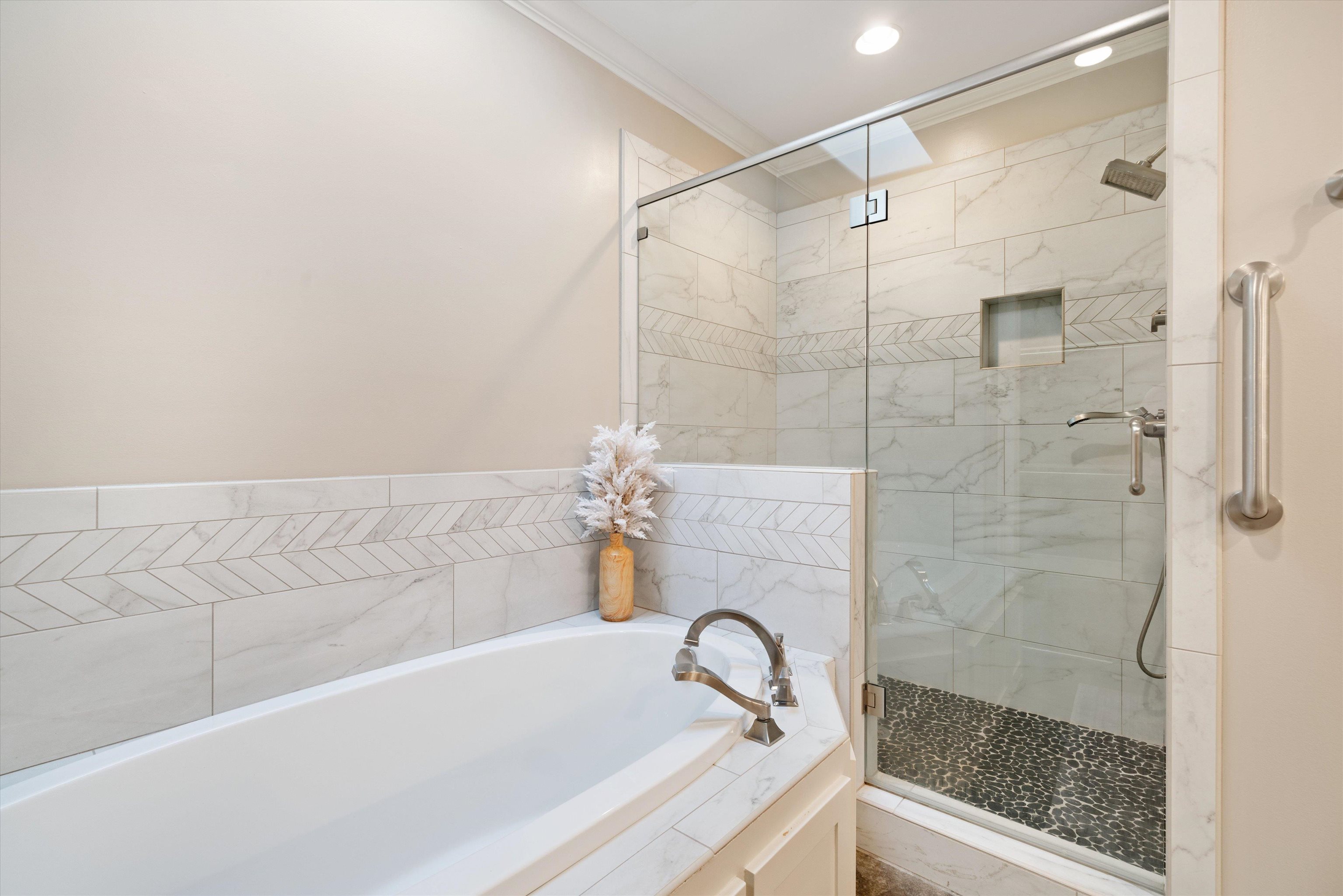 Bathroom with ornamental molding and independent shower and bath