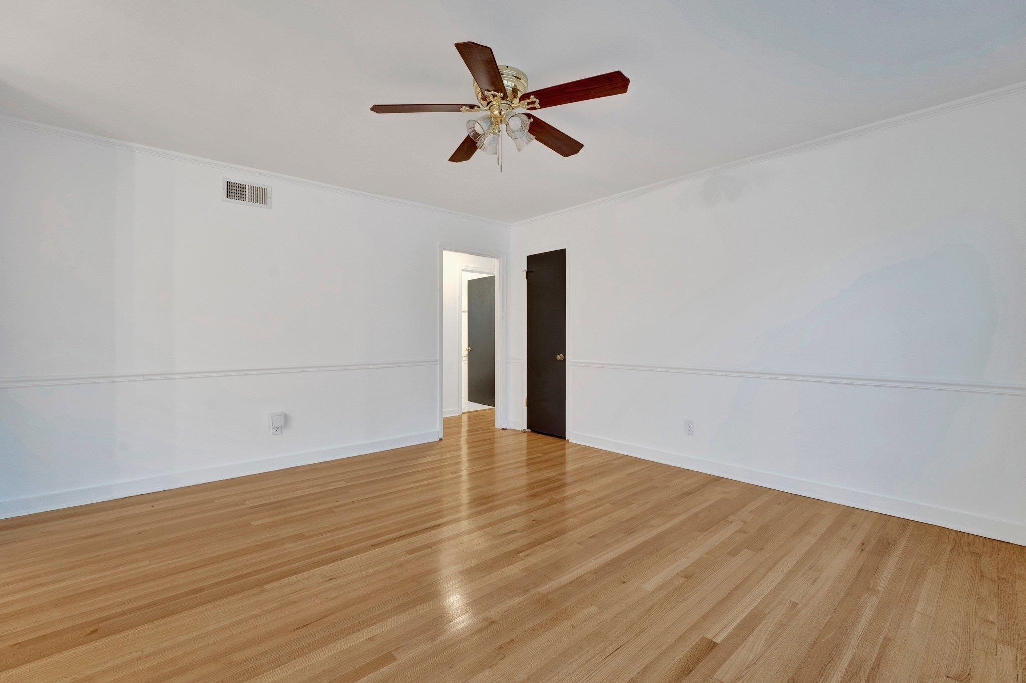 Spare room with ceiling fan, crown molding, and light hardwood / wood-style flooring