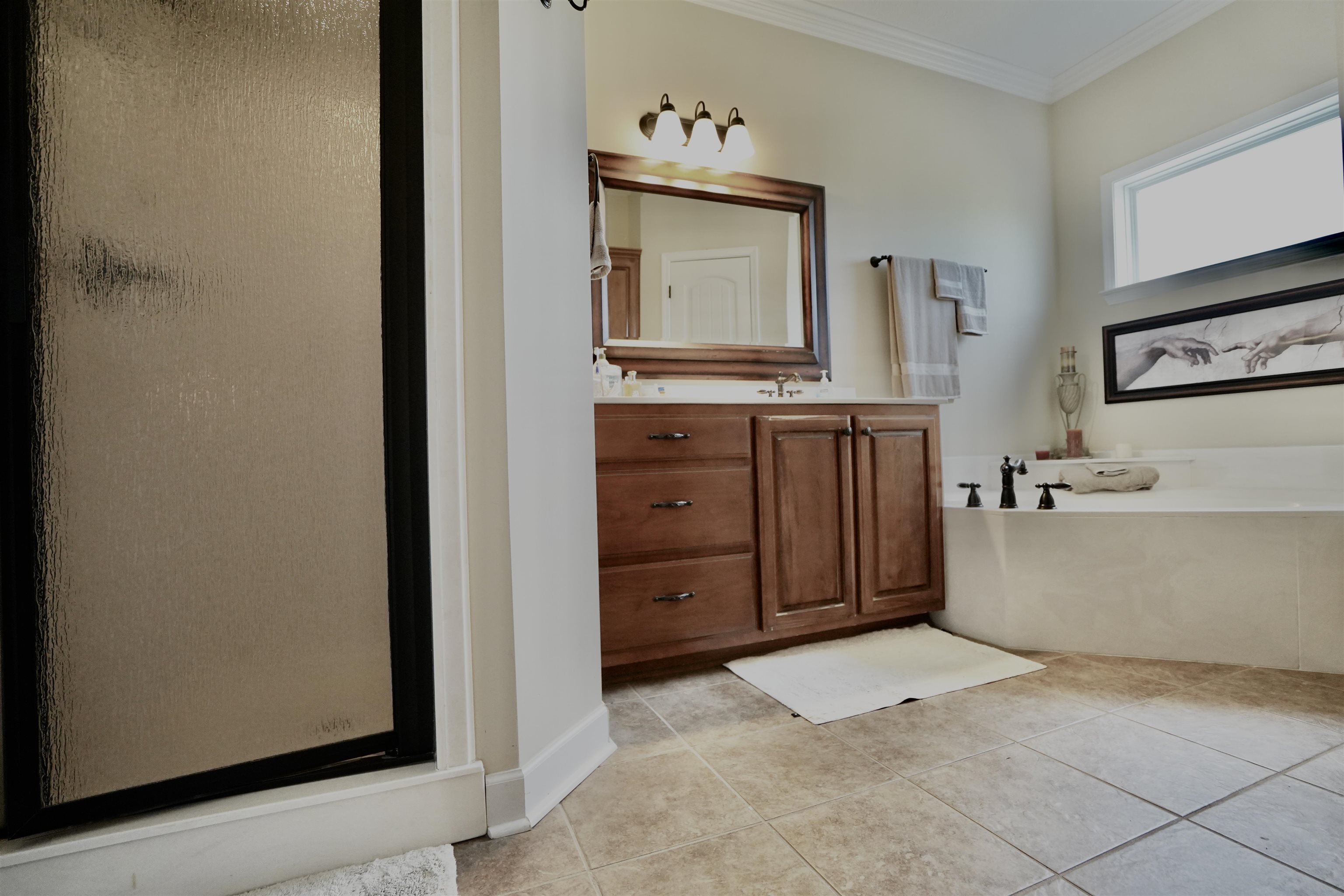 Bathroom featuring crown molding, vanity, separate shower and tub, and tile patterned floors