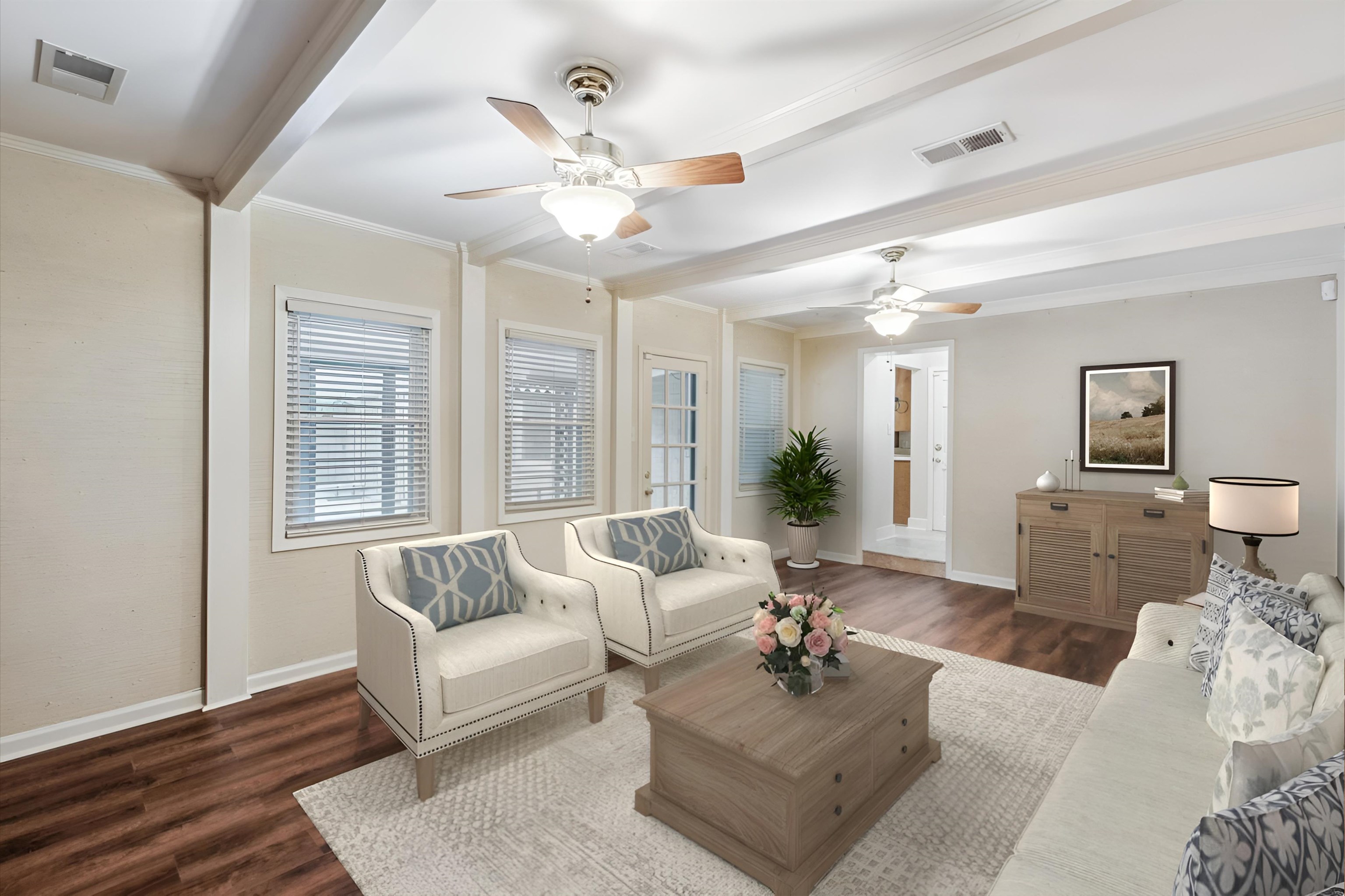 Living room with ornamental molding, beam ceiling, ceiling fan, and dark hardwood / wood-style floors