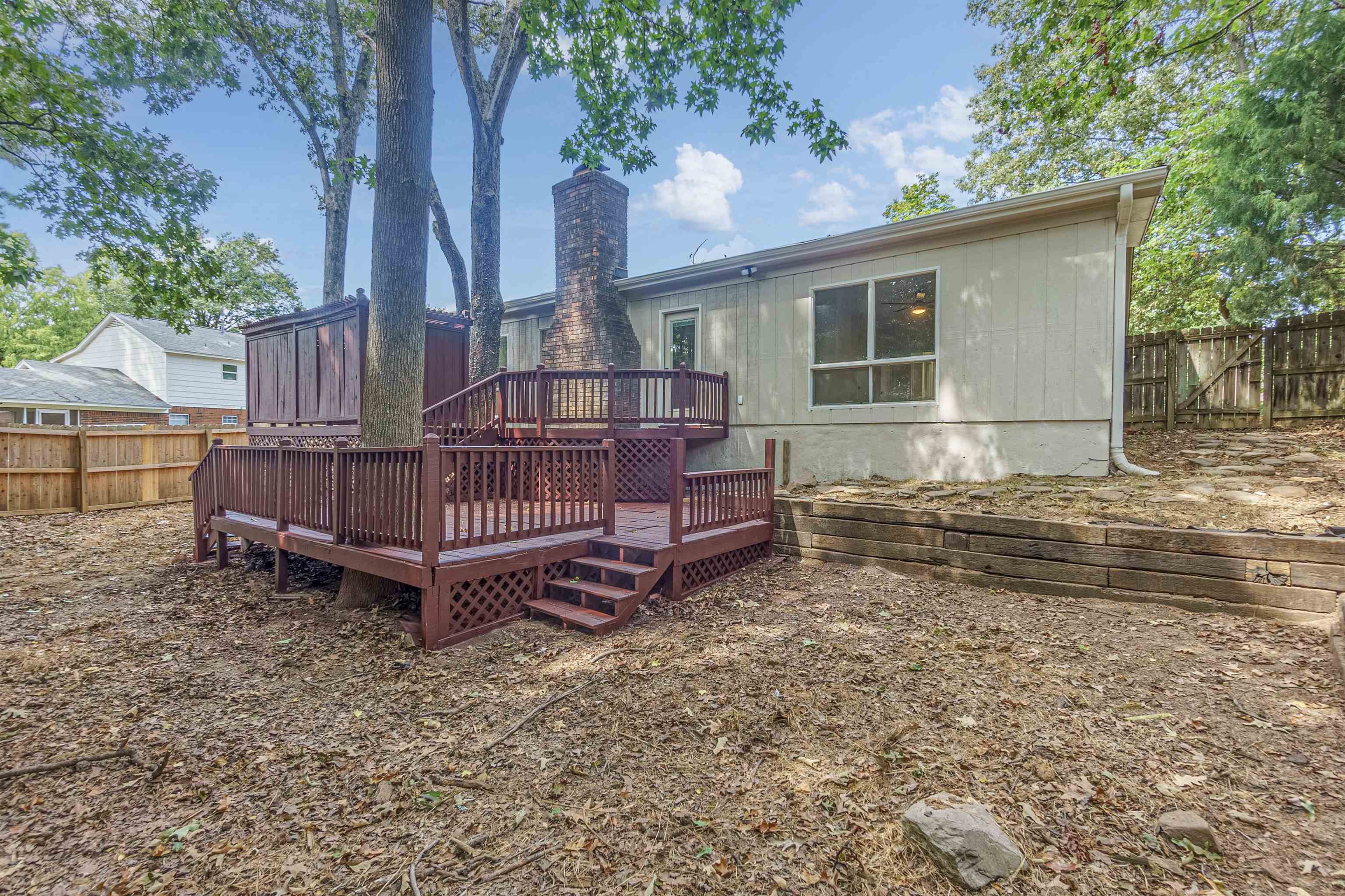 Rear view of property featuring a wooden deck