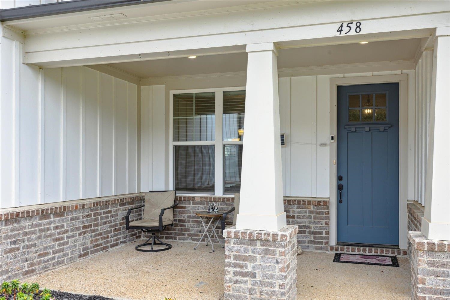 Entrance to property featuring covered porch