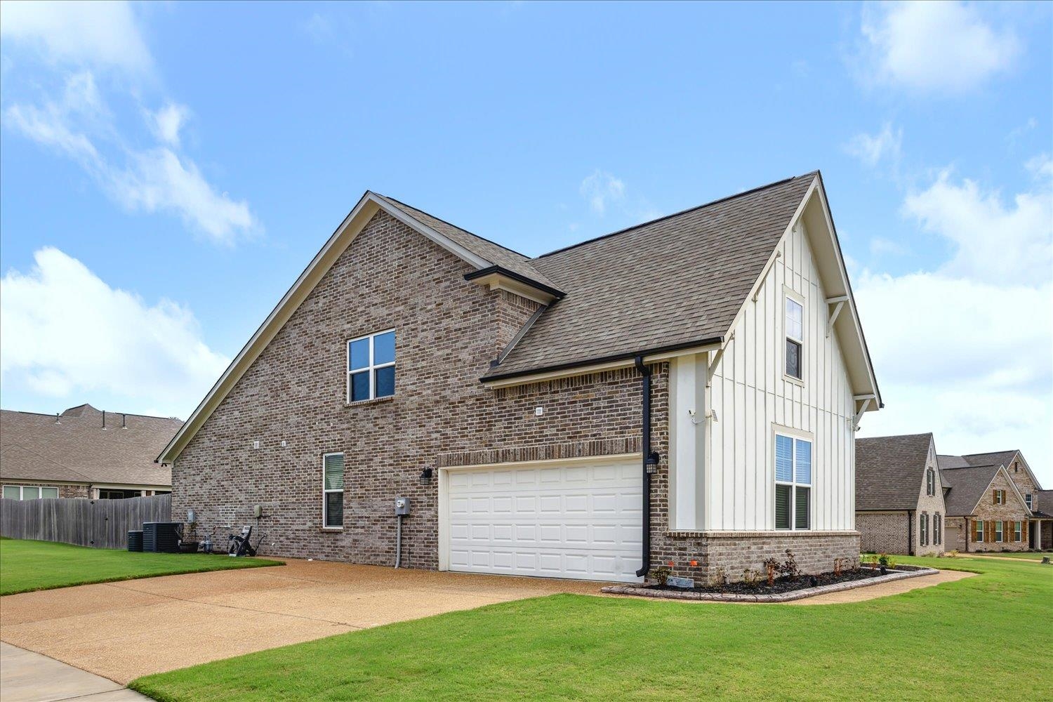 View of front facade with a front lawn and a garage