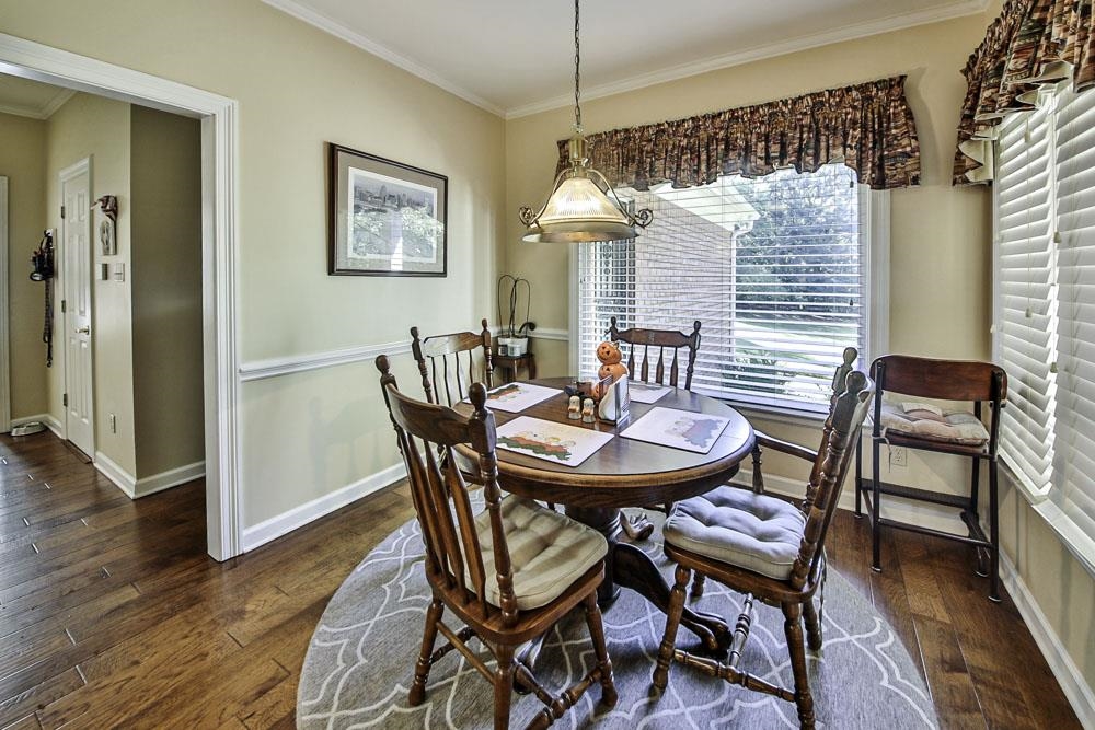 Dining room featuring crown molding and dark hardwood / wood-style floors