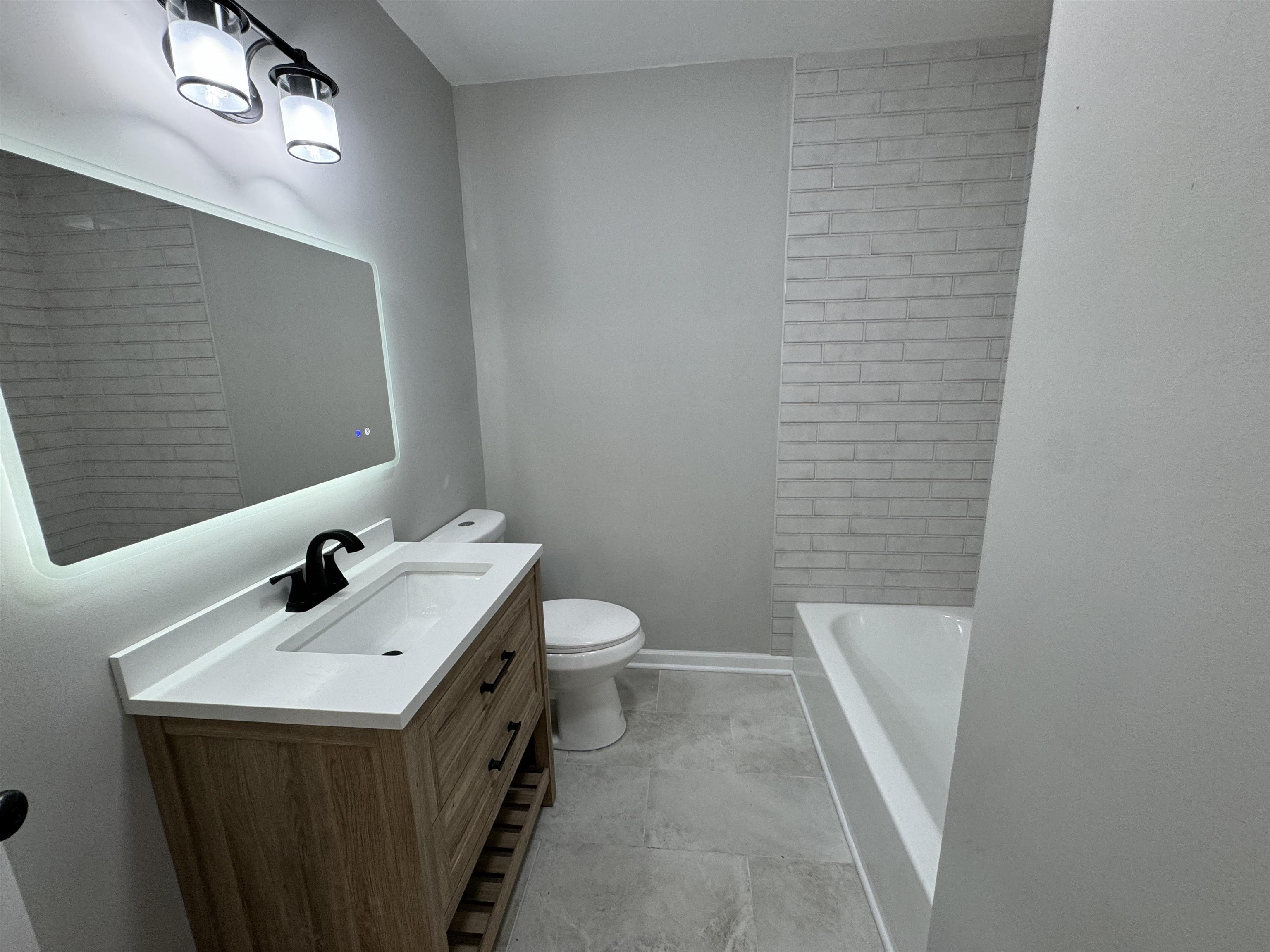 Bathroom featuring vanity, toilet, and tile patterned floors