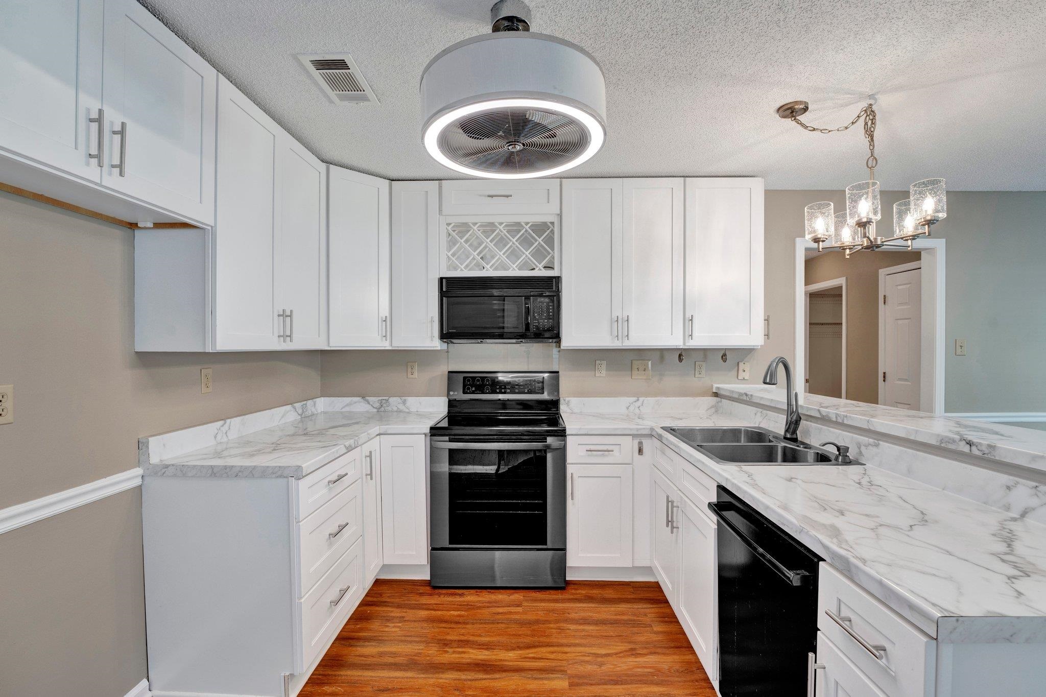 Kitchen was renovated with new cabinets, lighting and LVT flooring.