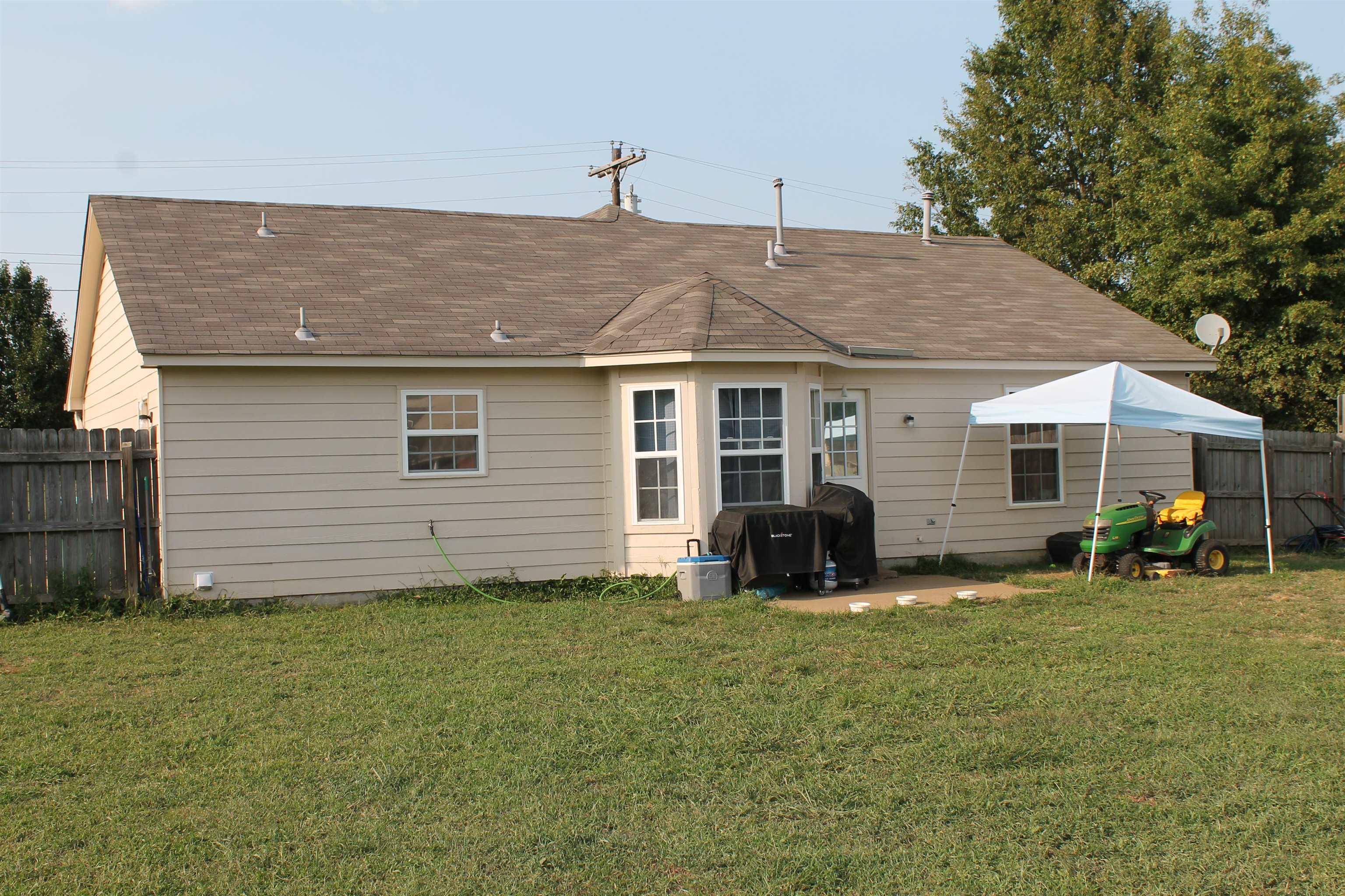 Rear view of house with a yard