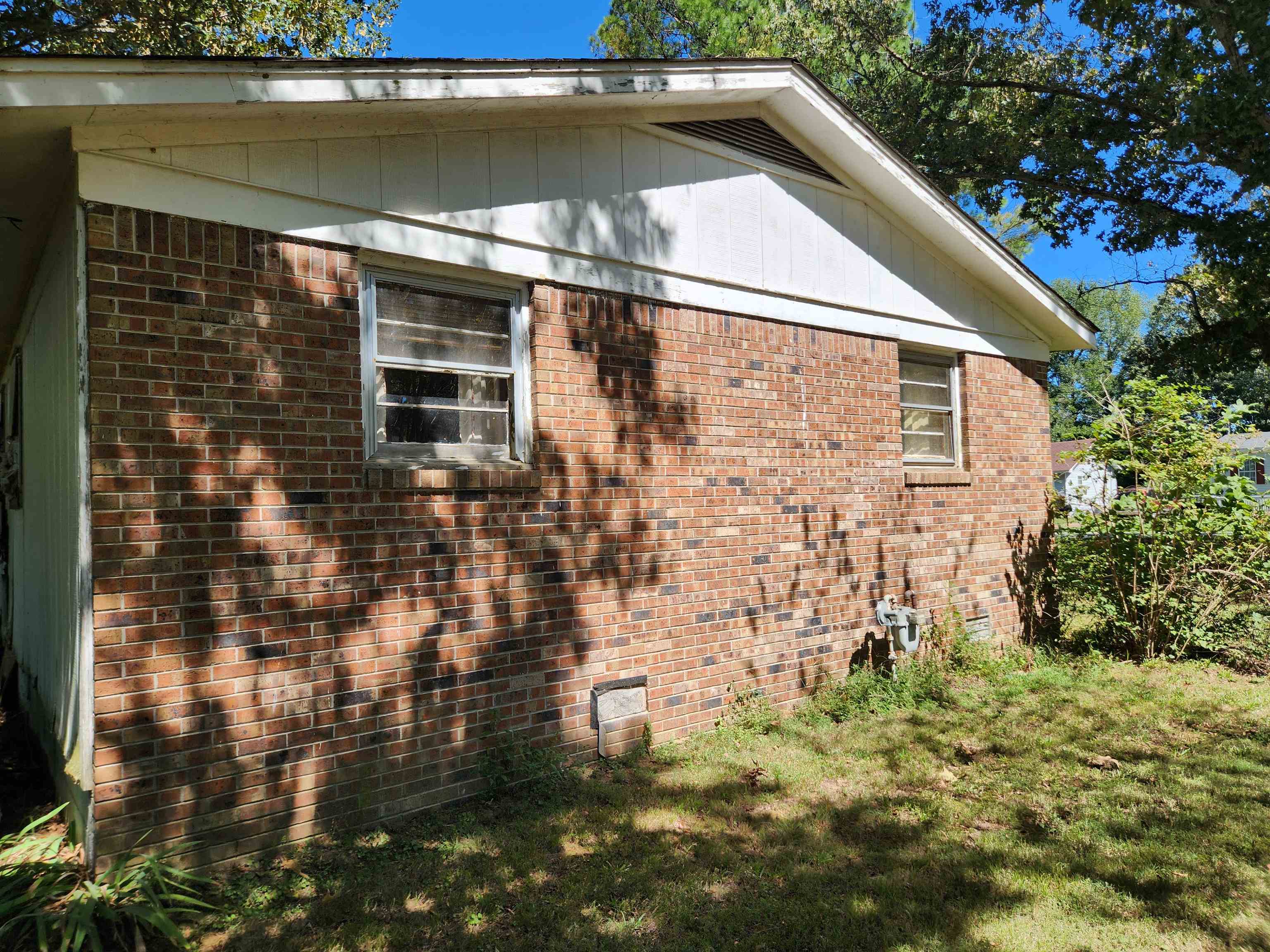 View of side of property with a yard