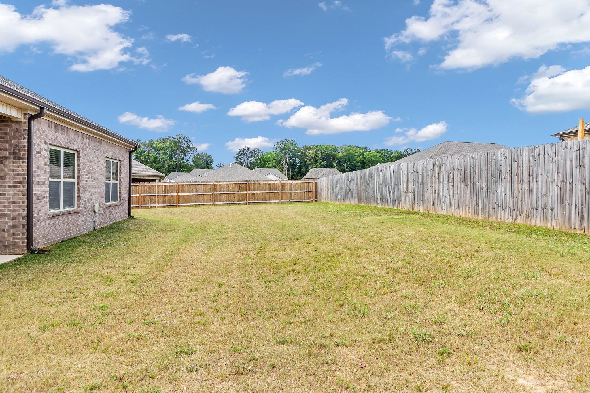 A view of the yard showcases its spacious and inviting layout.