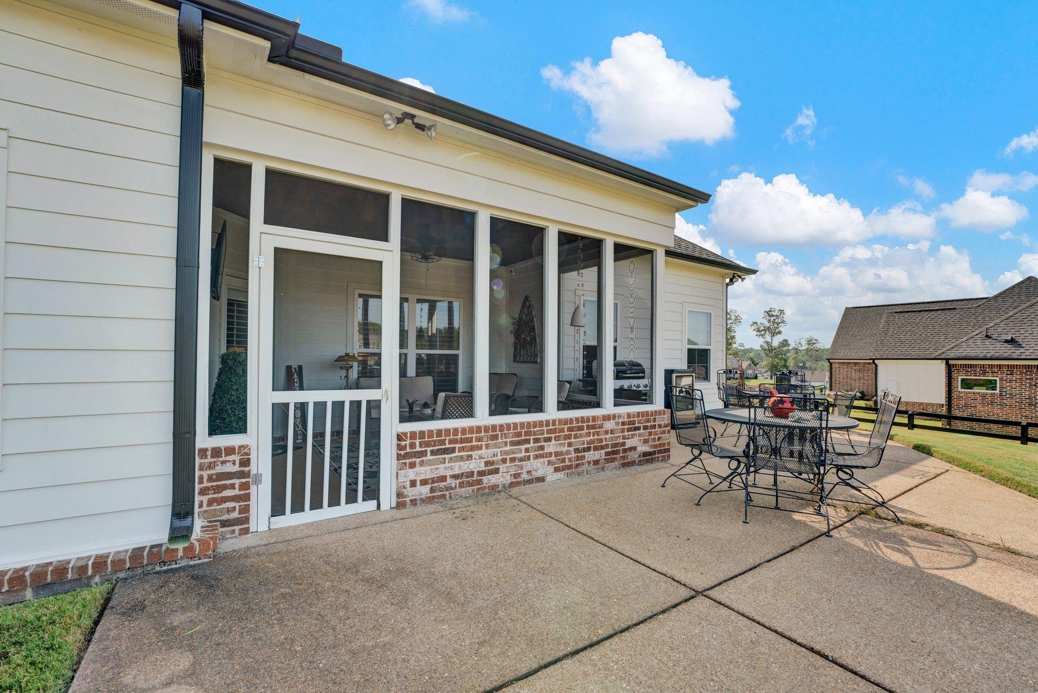 View of patio featuring a sunroom