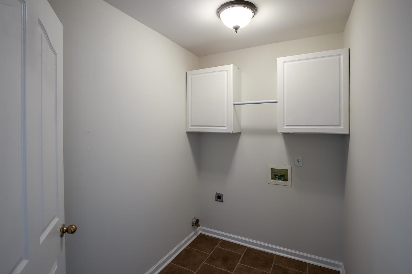 Laundry room with hookup for a washing machine, hookup for an electric dryer, and cabinets