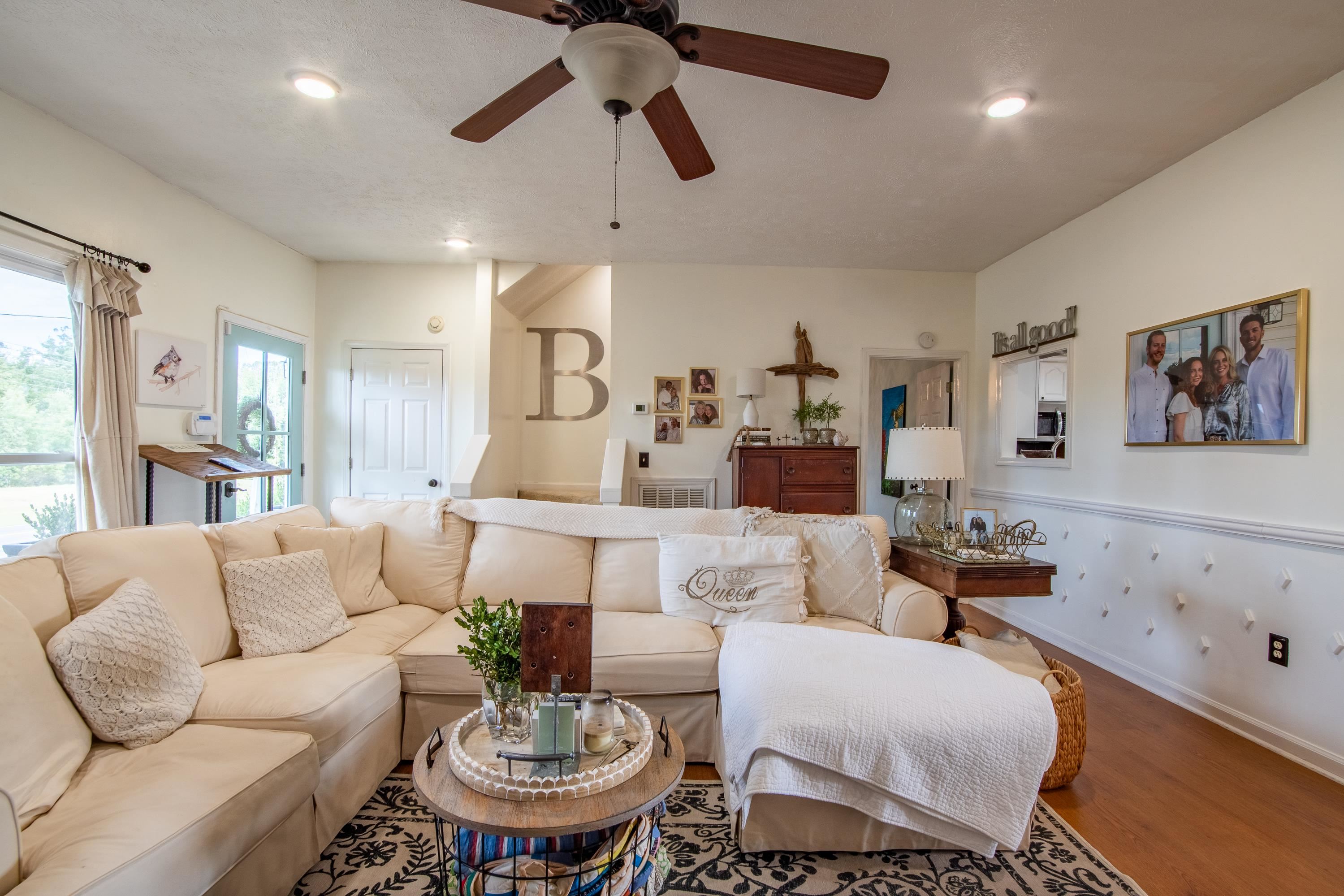 Living room with hardwood / wood-style floors and ceiling fan