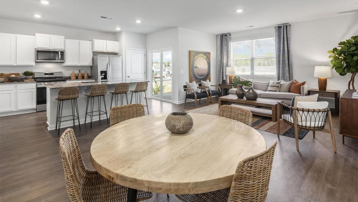 Dining area with dark wood-type flooring and sink