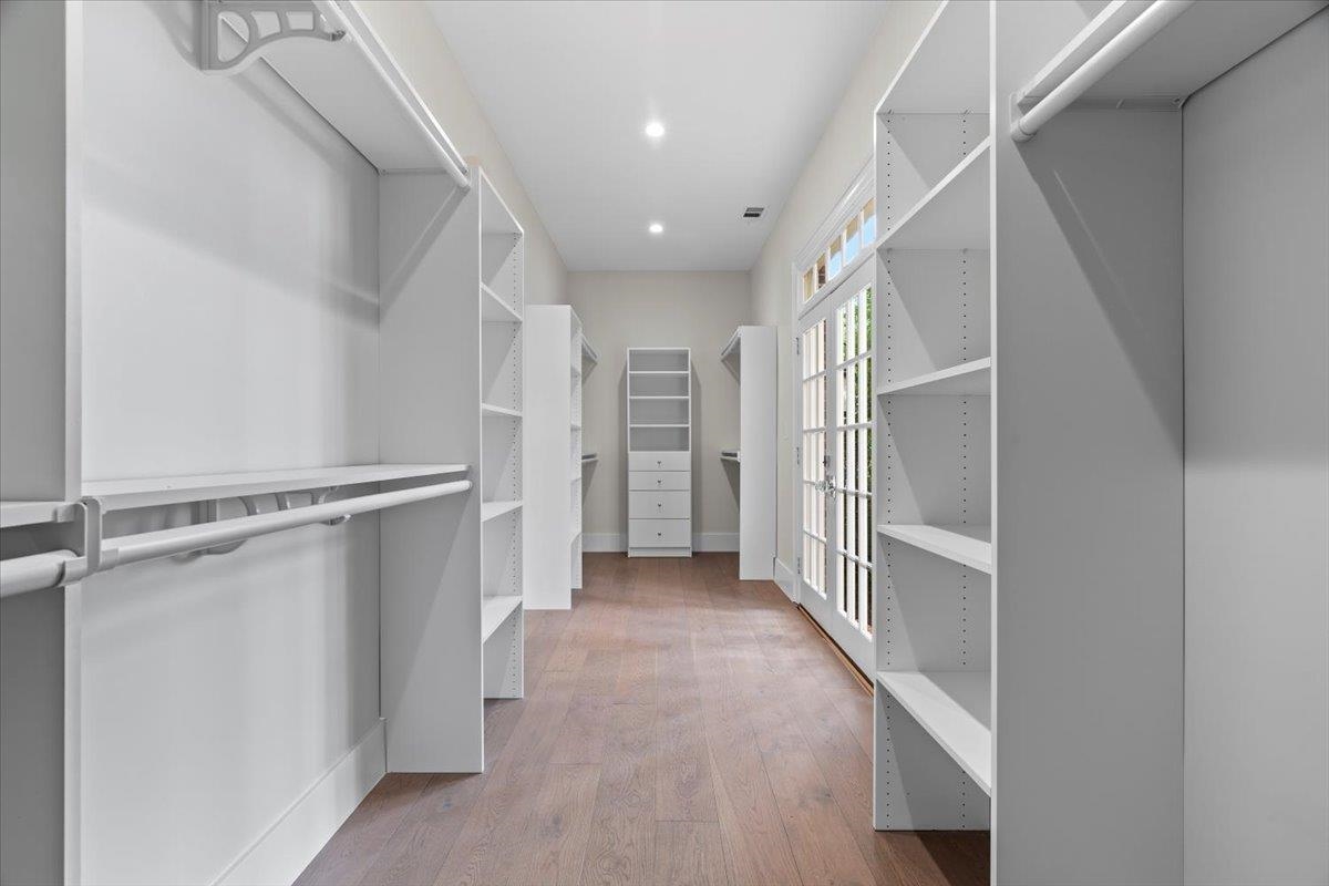 Spacious closet with light wood-type flooring